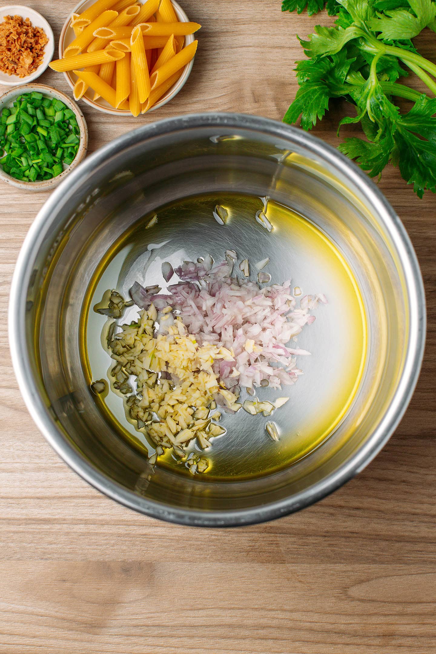 Minced shallots and garlic with olive oil in a deep pot.