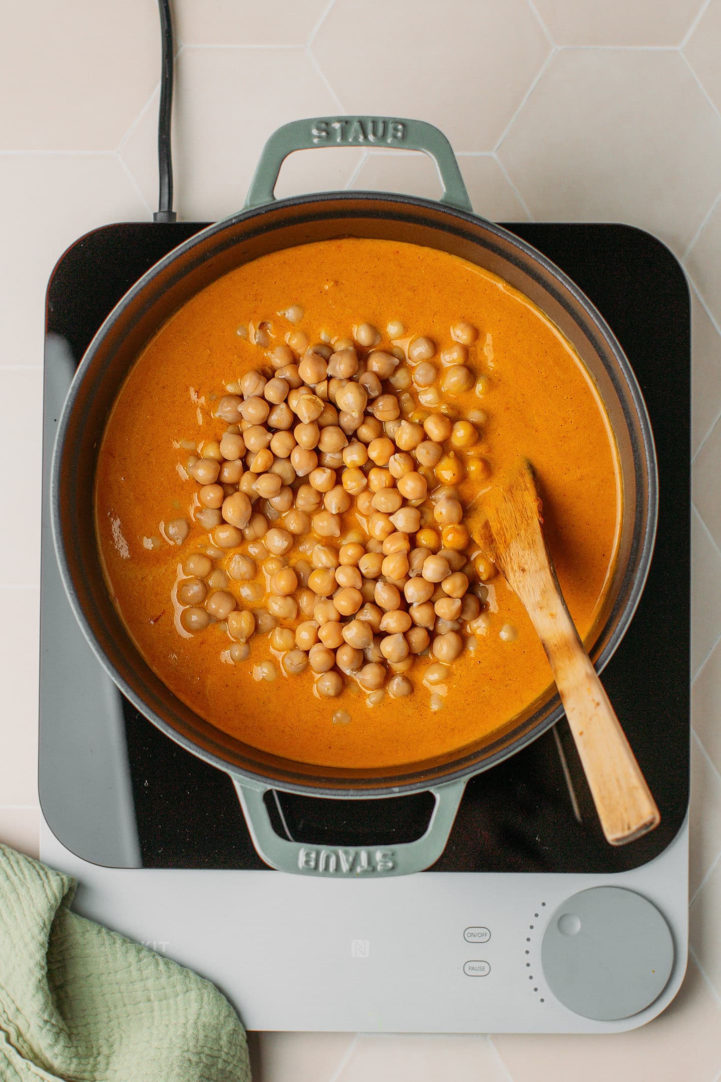 Curry sauce and cooked chickpeas in a pot.