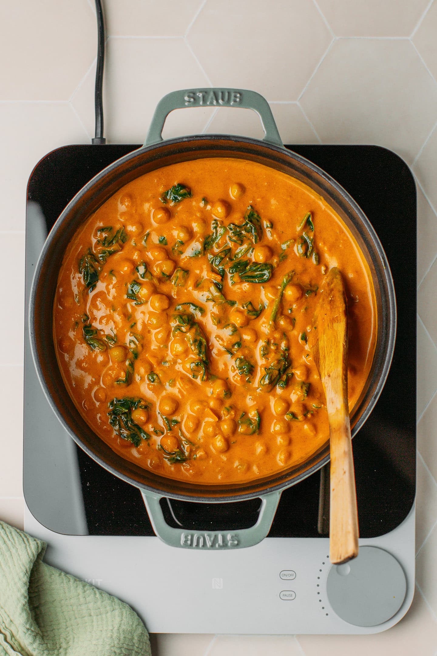 Large pot of chickpea curry with spinach.