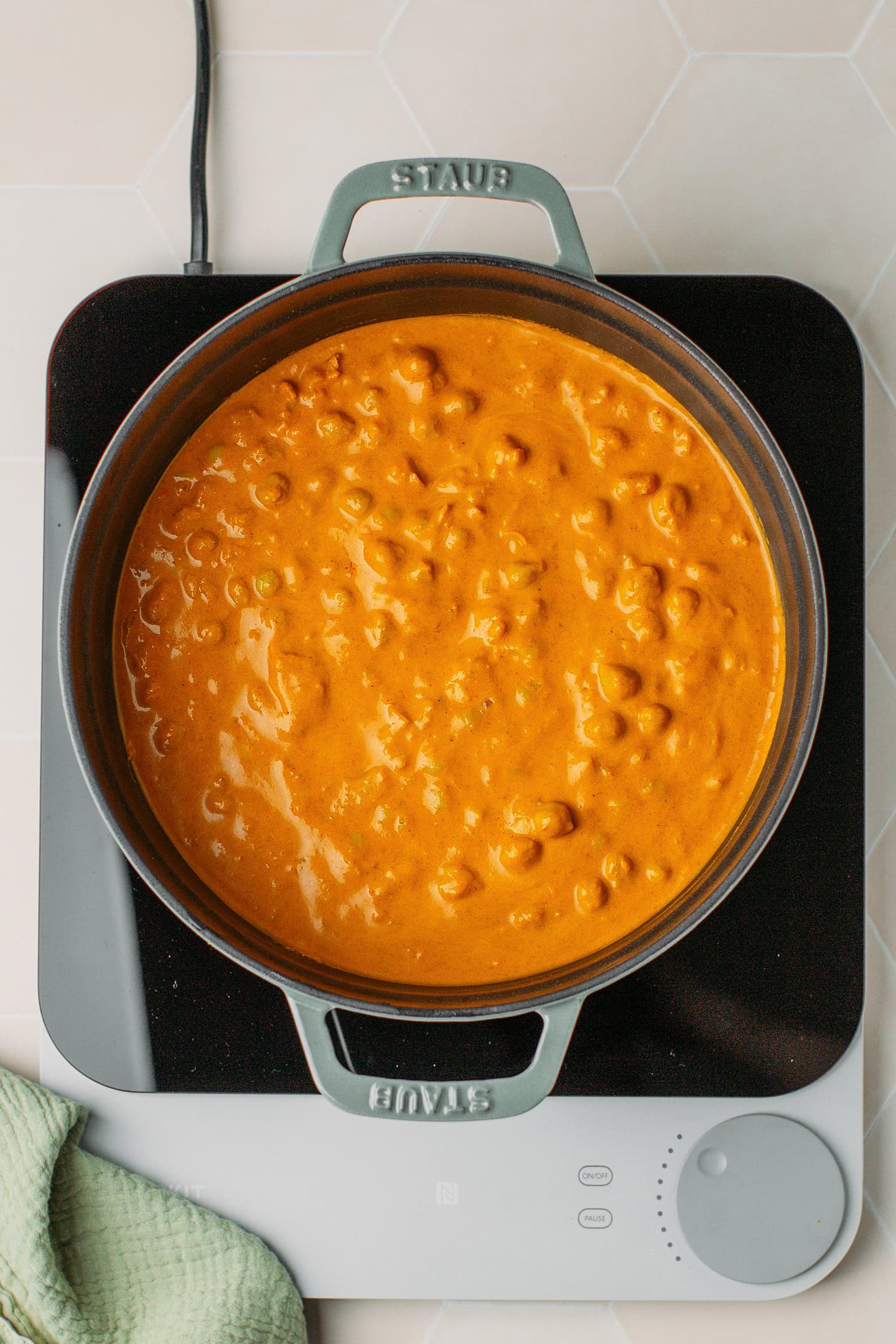 Cooked chickpea curry in a Dutch oven.