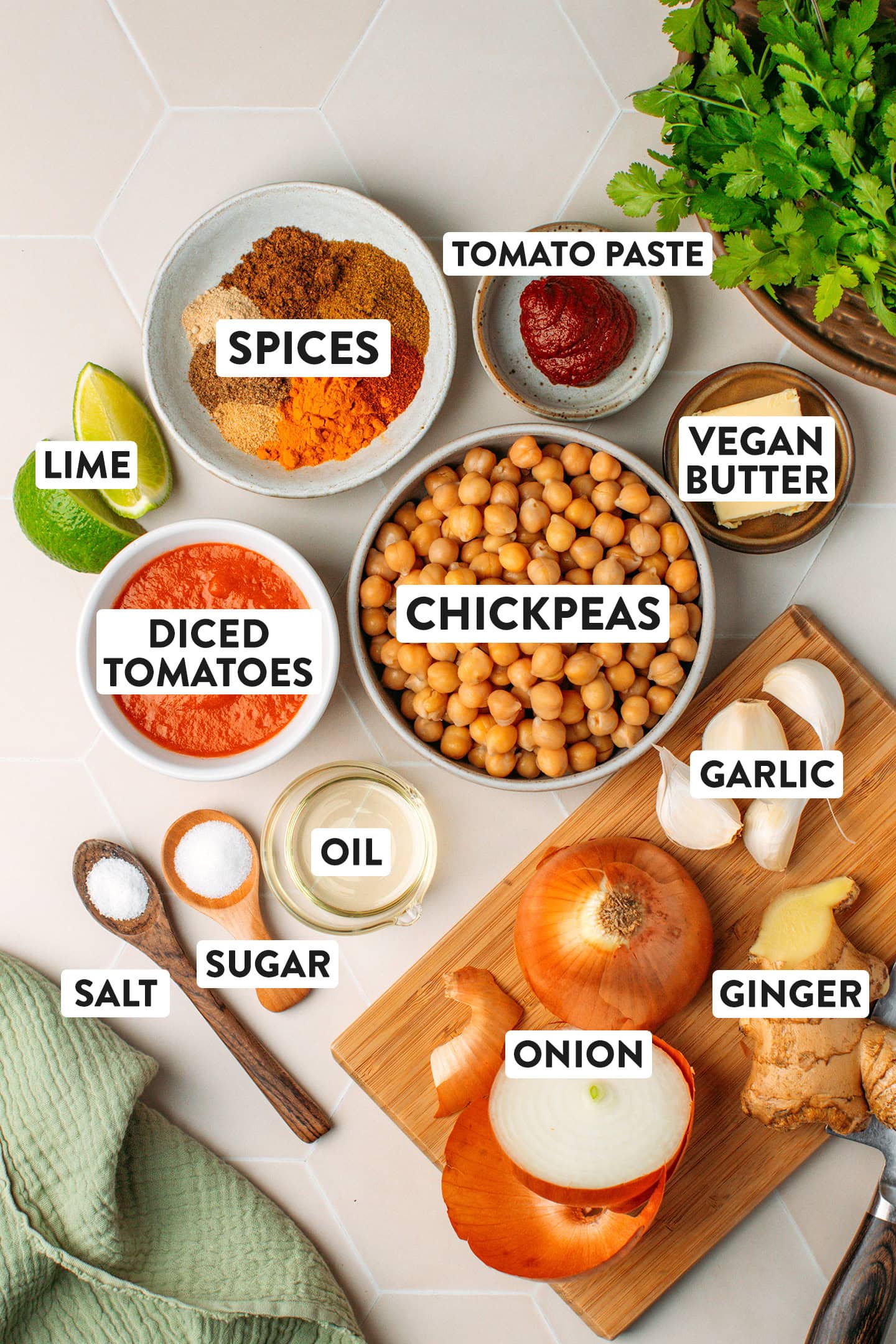 Ingredients like chickpeas, diced tomatoes, onion, garlic, and ginger.