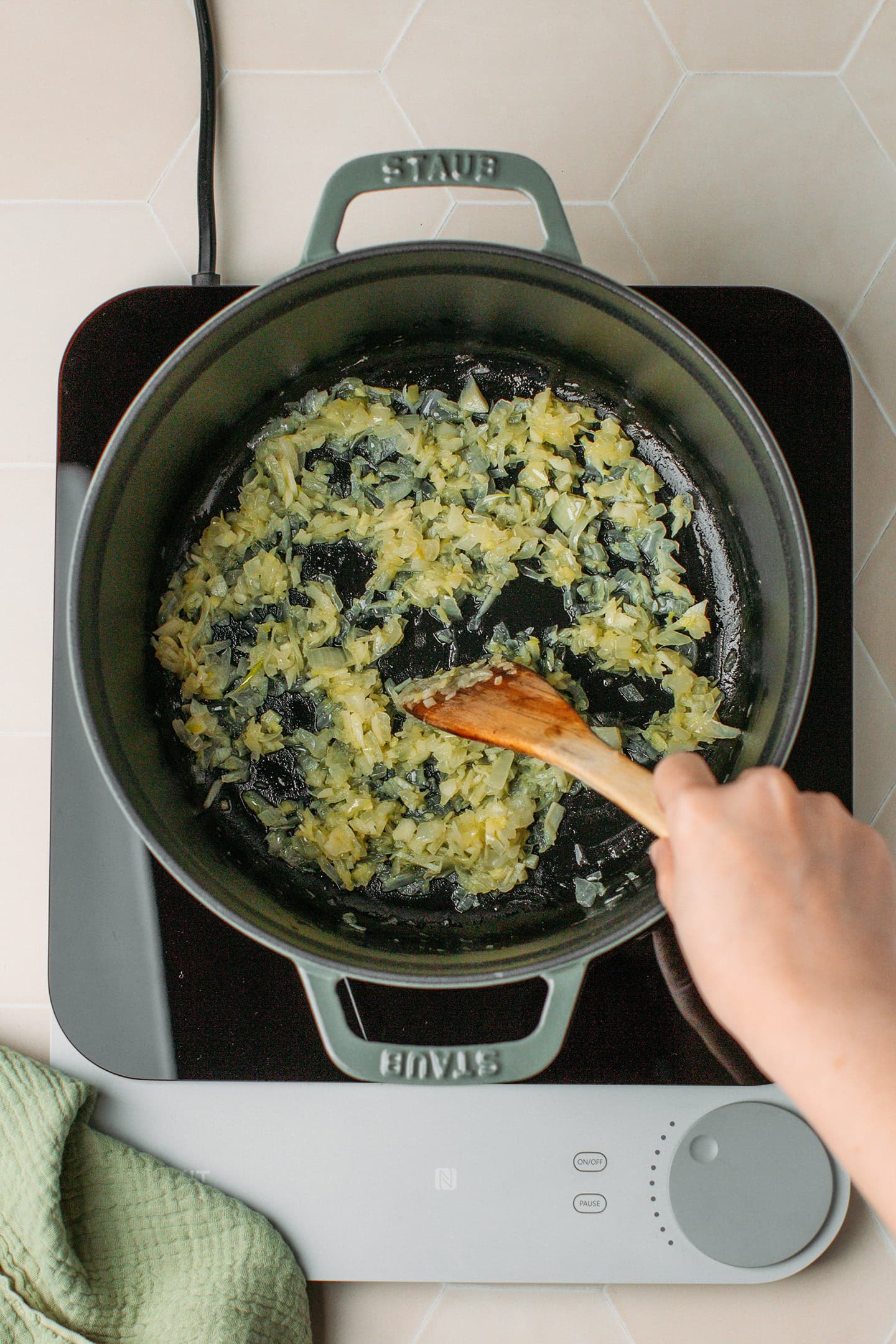 Saut&eacute;ed onion, garlic, and ginger in a deep pot.