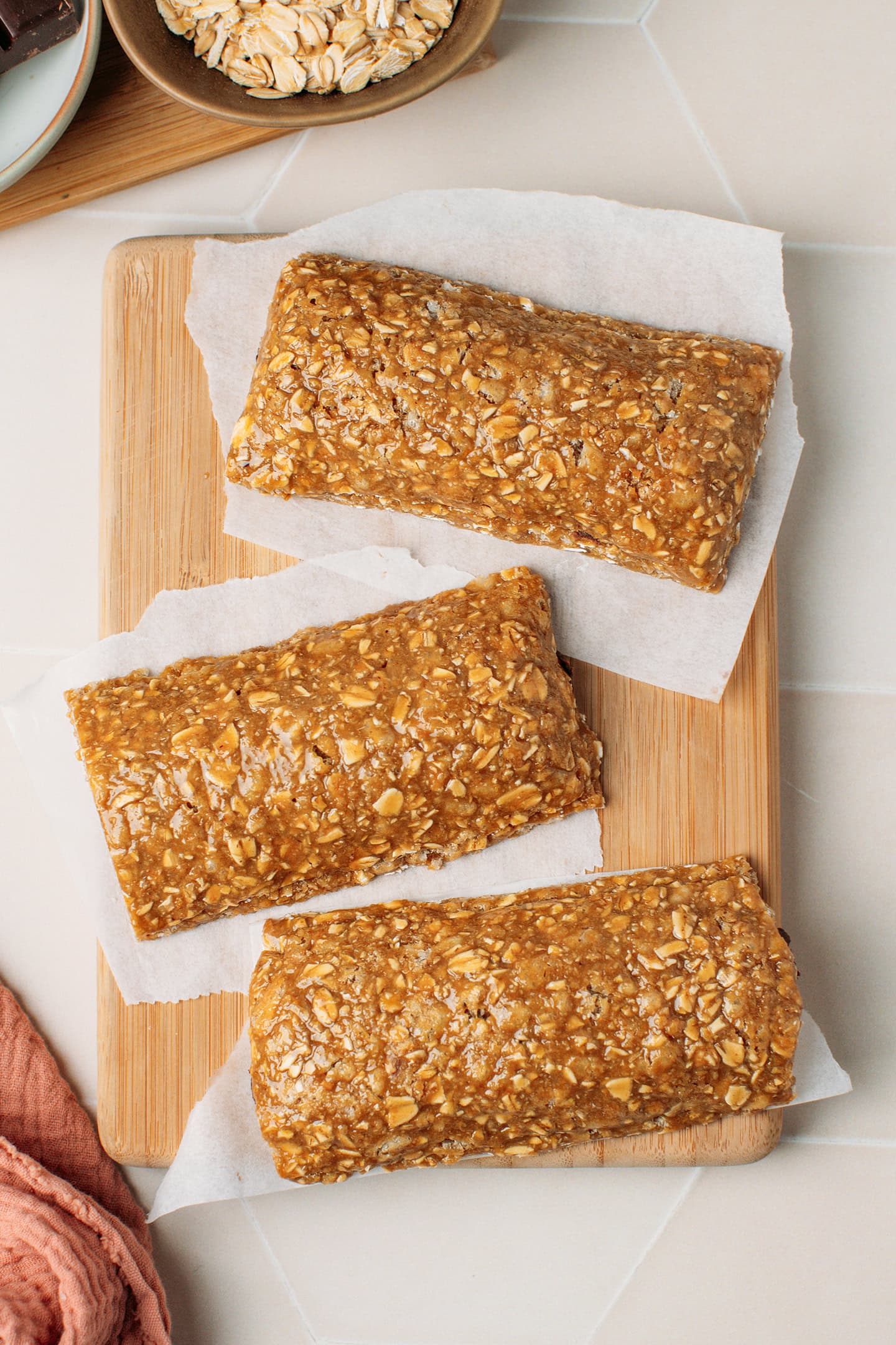 Three soft granola bars on a cutting board.