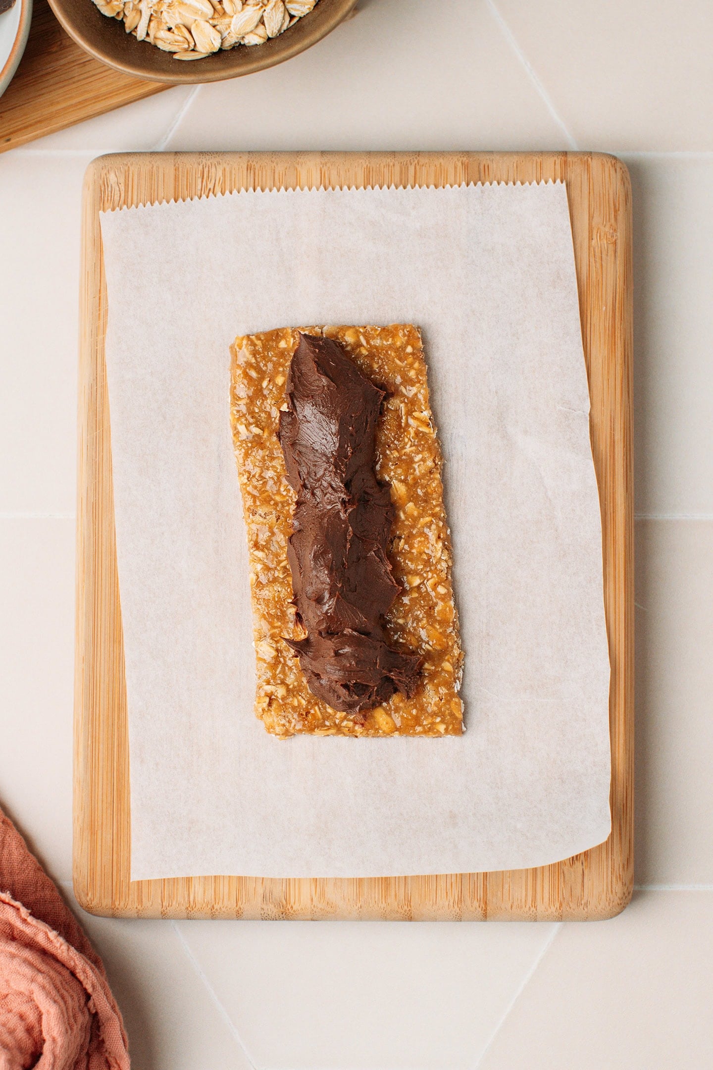 Granola bar topped with a dollop of chocolate hazelnut filling.