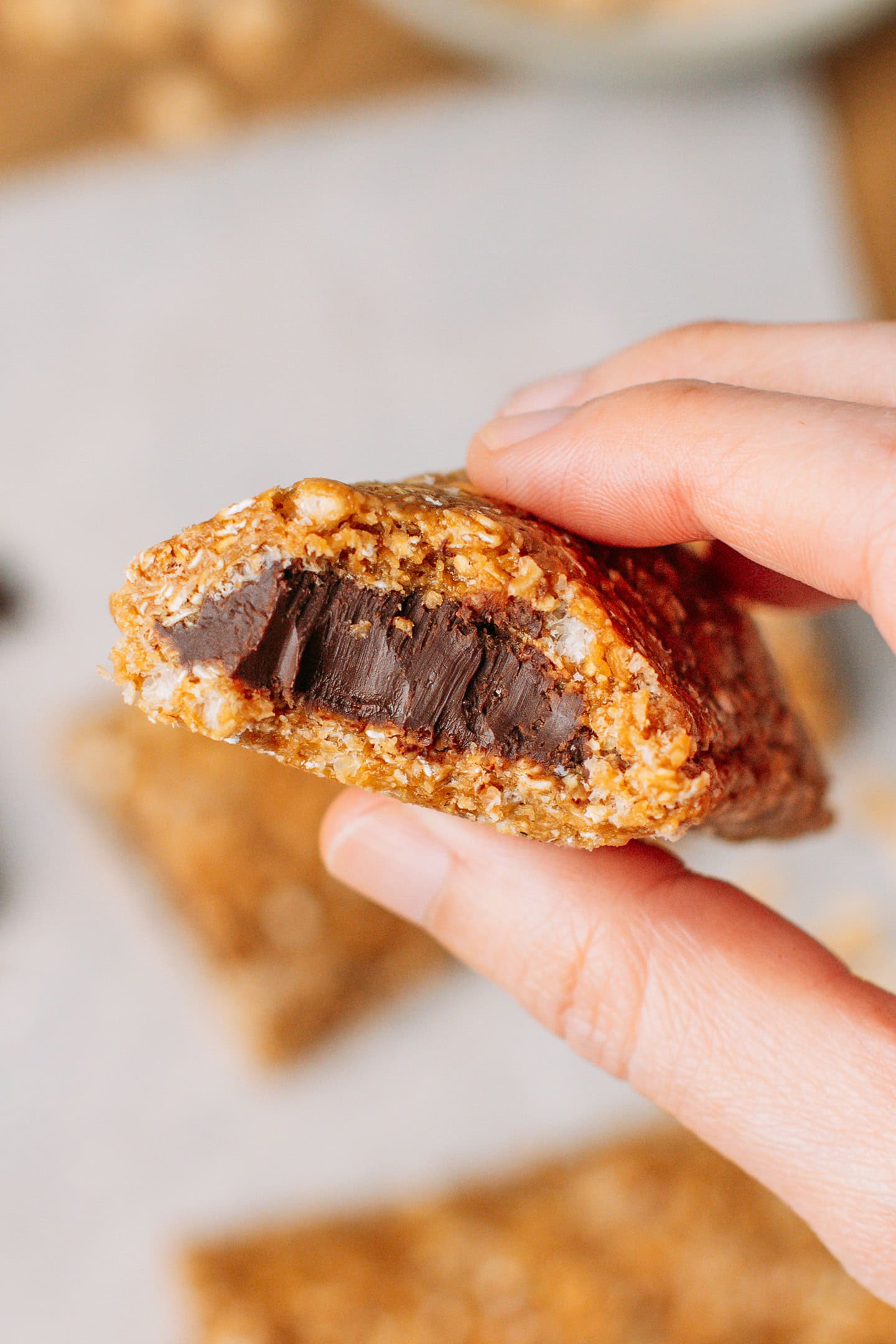 Holding a soft granola bar filled with a chocolate hazelnut filling.