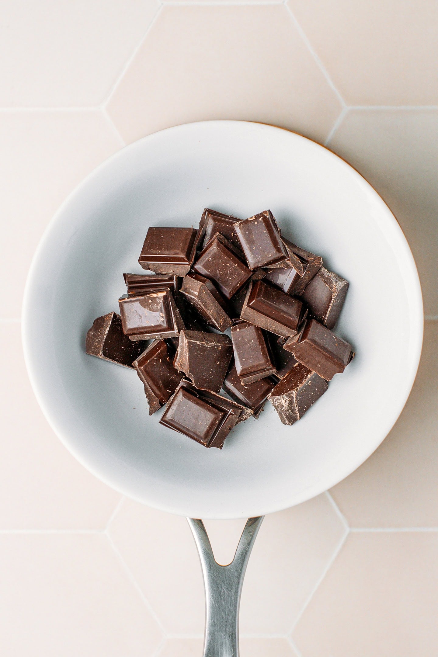 Dark chocolate chunks in a double boiler.