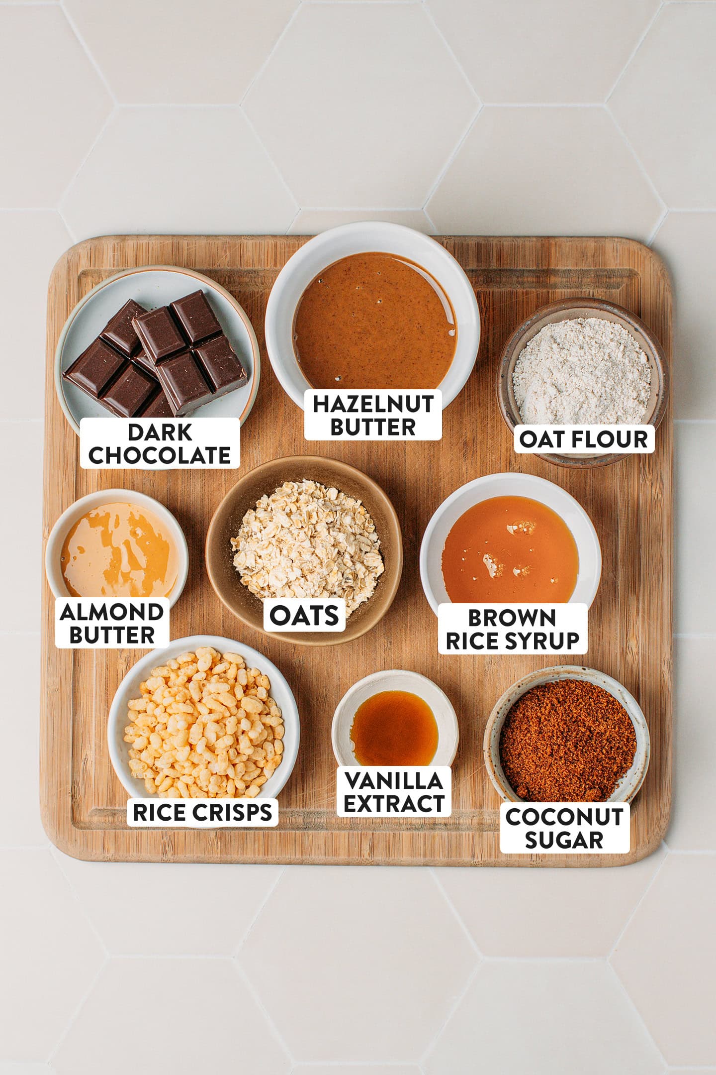 Ingredients like rice crisps, oats, dark chocolate, and hazelnut butter.