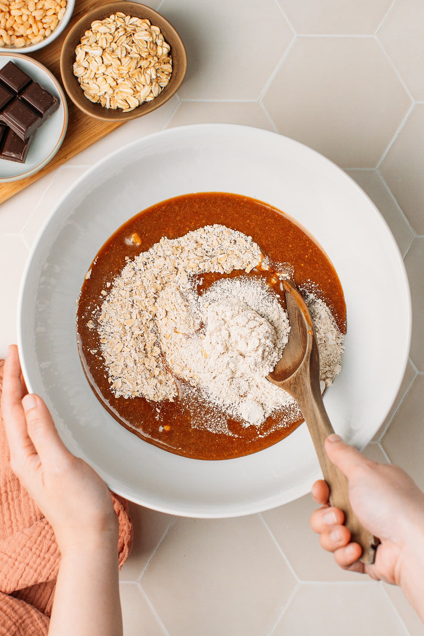 Melted brown rice syrup, oats, and oat flour in a bowl.