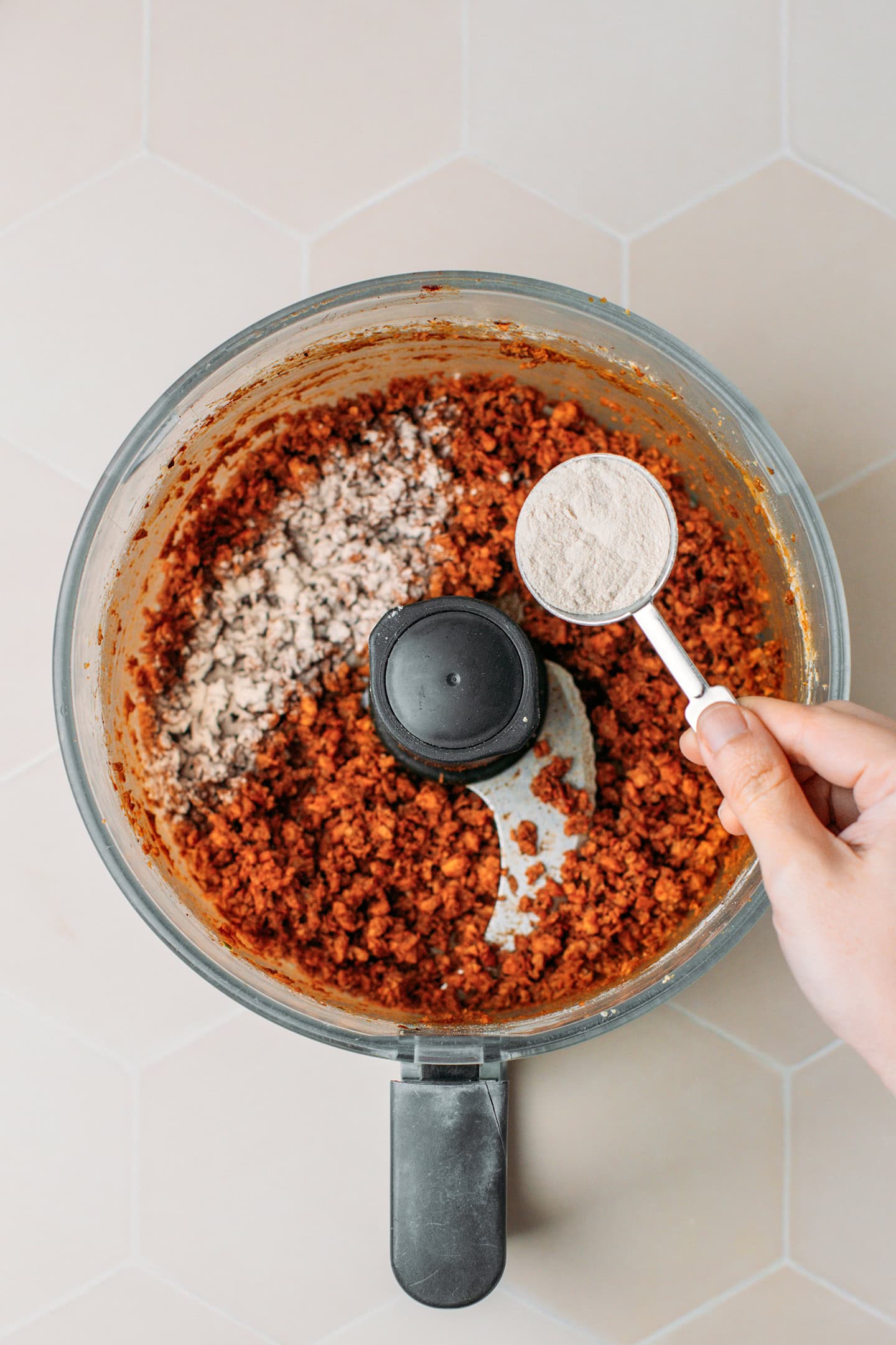 Adding psyllium husk to a food processor containing ground TVP.