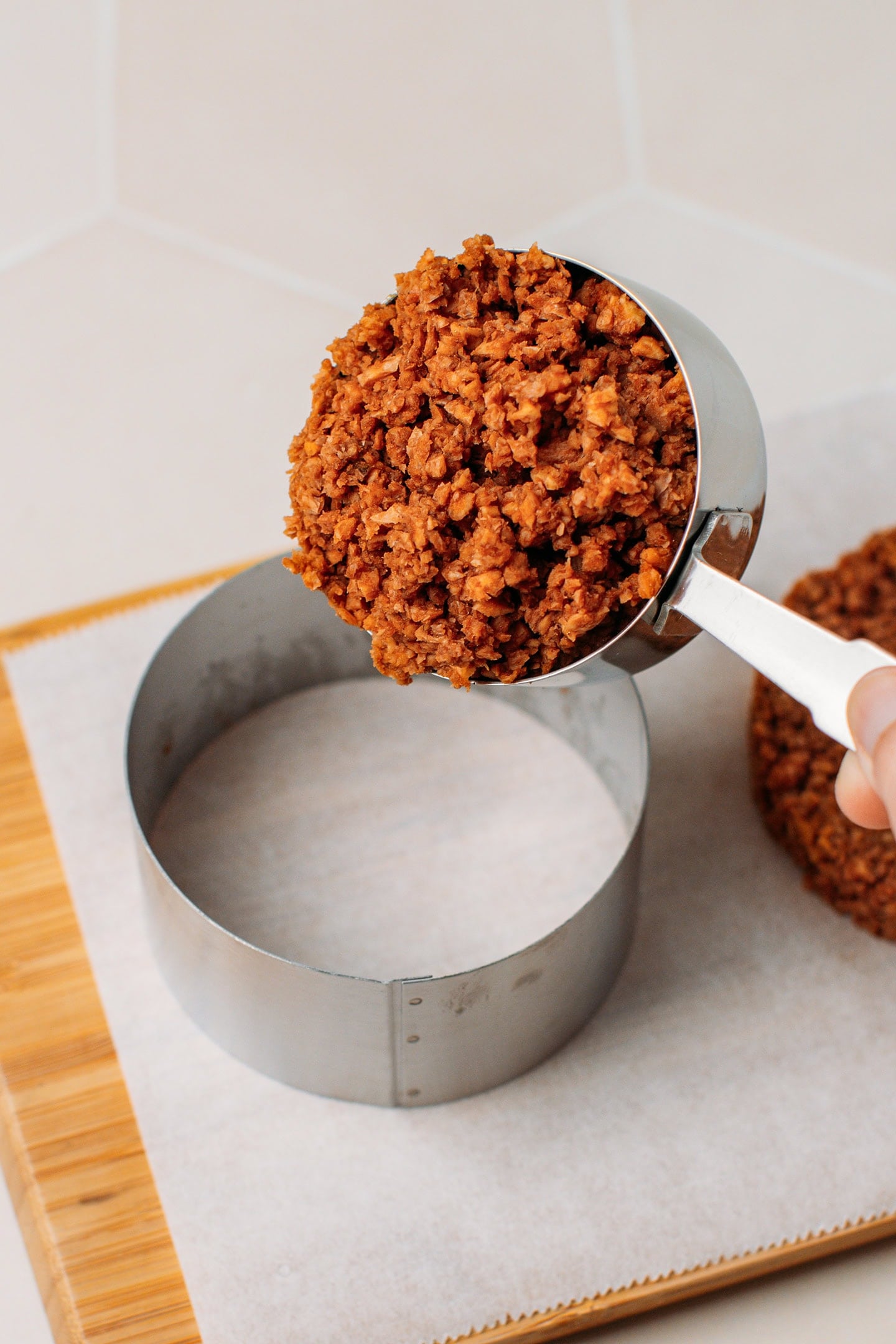 Adding TVP mixture to a pastry ring.