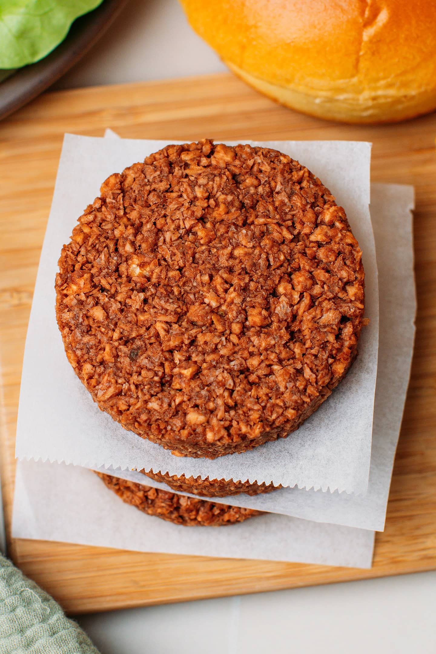 Close-up of a vegan patty on a piece of parchment paper.