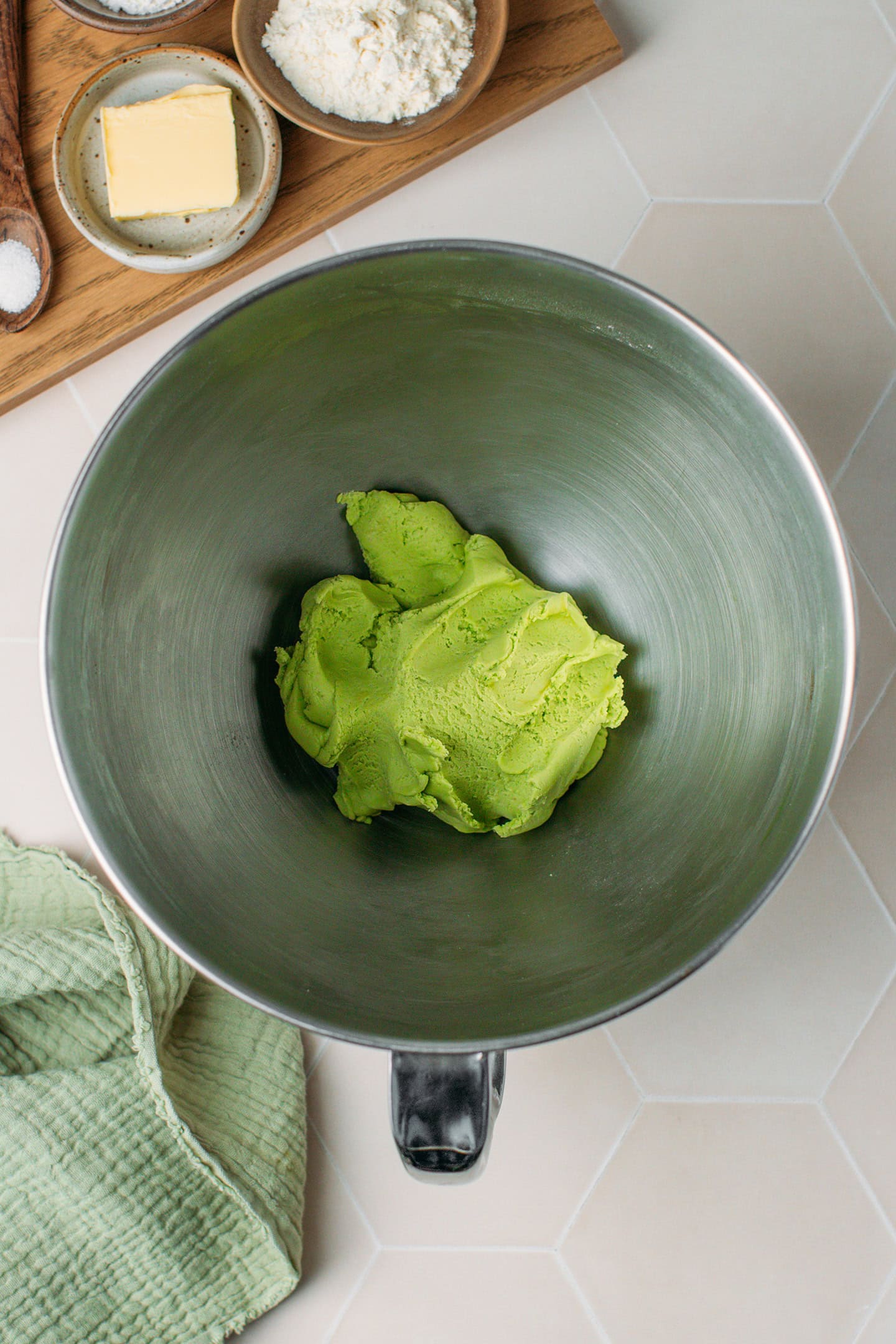 Green cookie dough in a stand mixer.