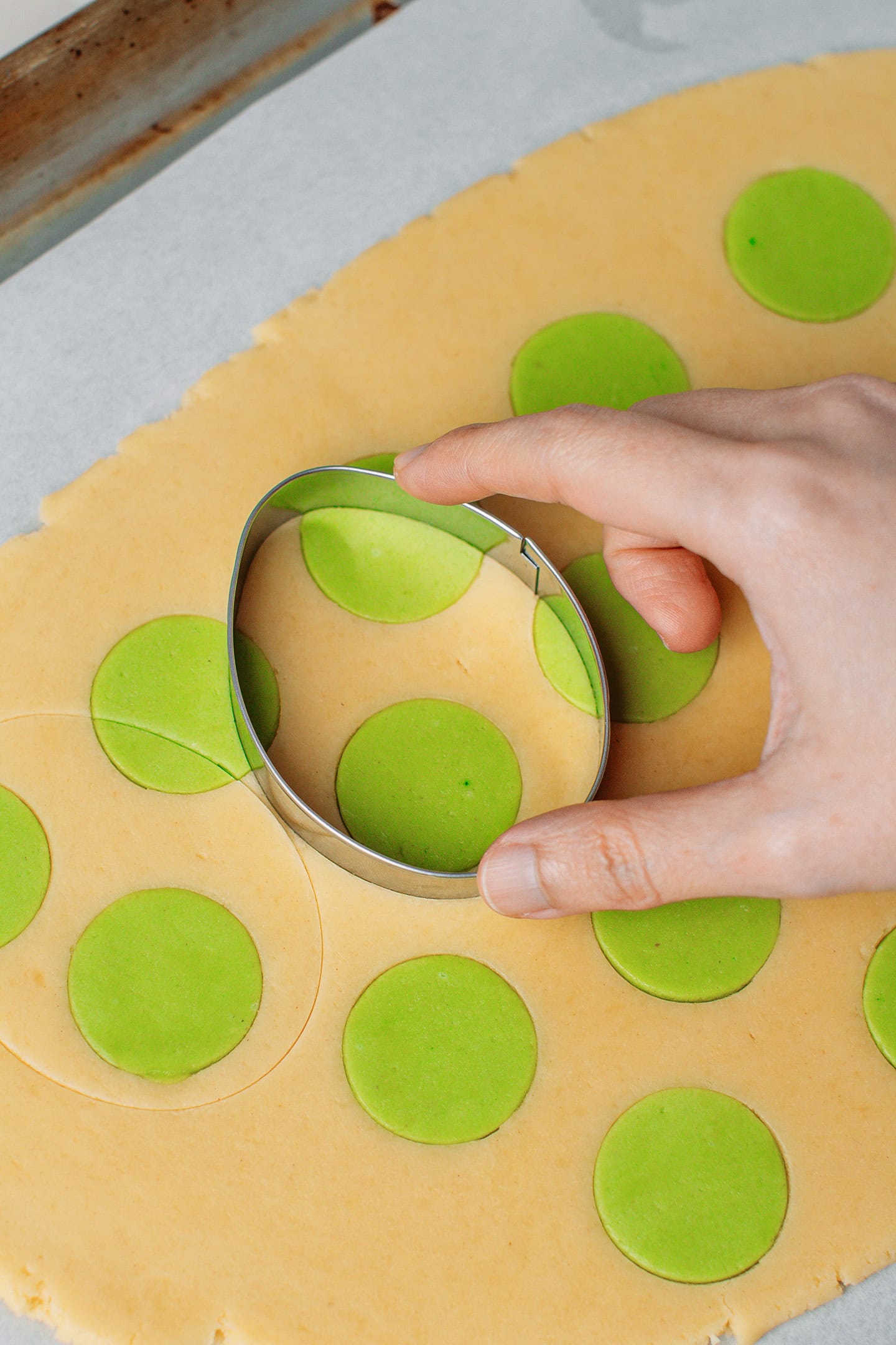 Cutting out egg-shaped cookie using a cookie cutter.
