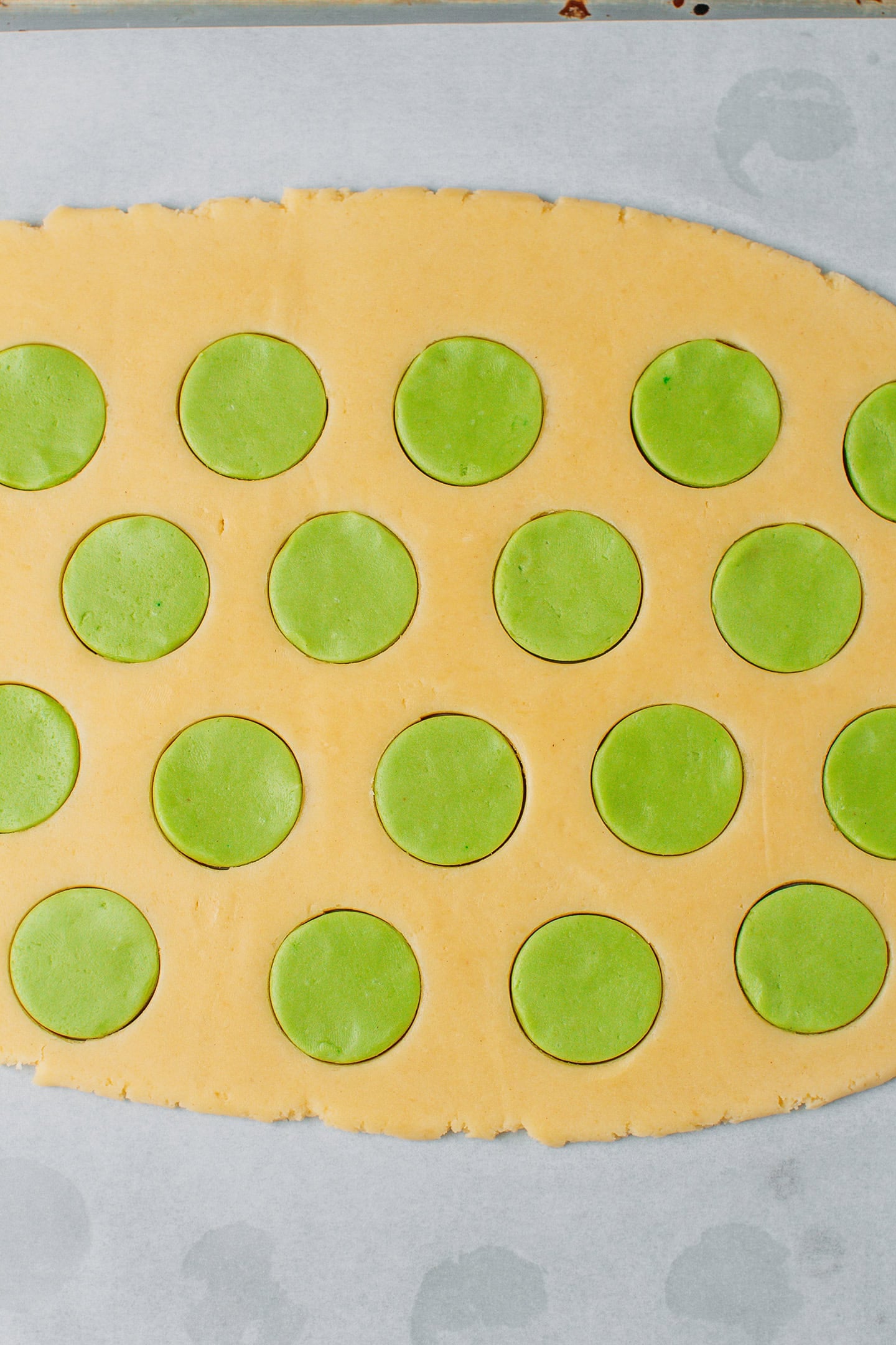 Flattened cookie dough with dots of green.