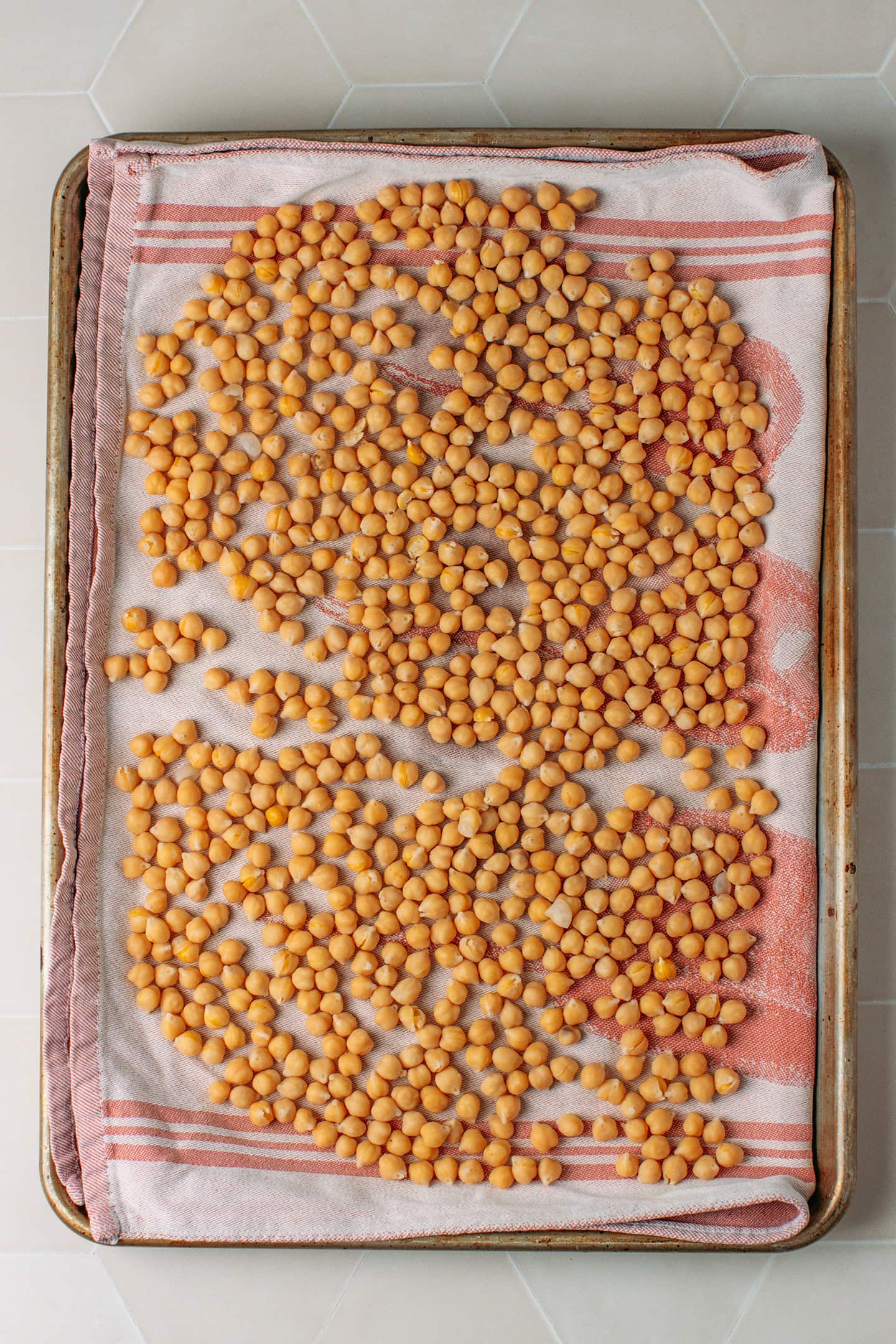 Cooked chickpeas spread on a kitchen towel.