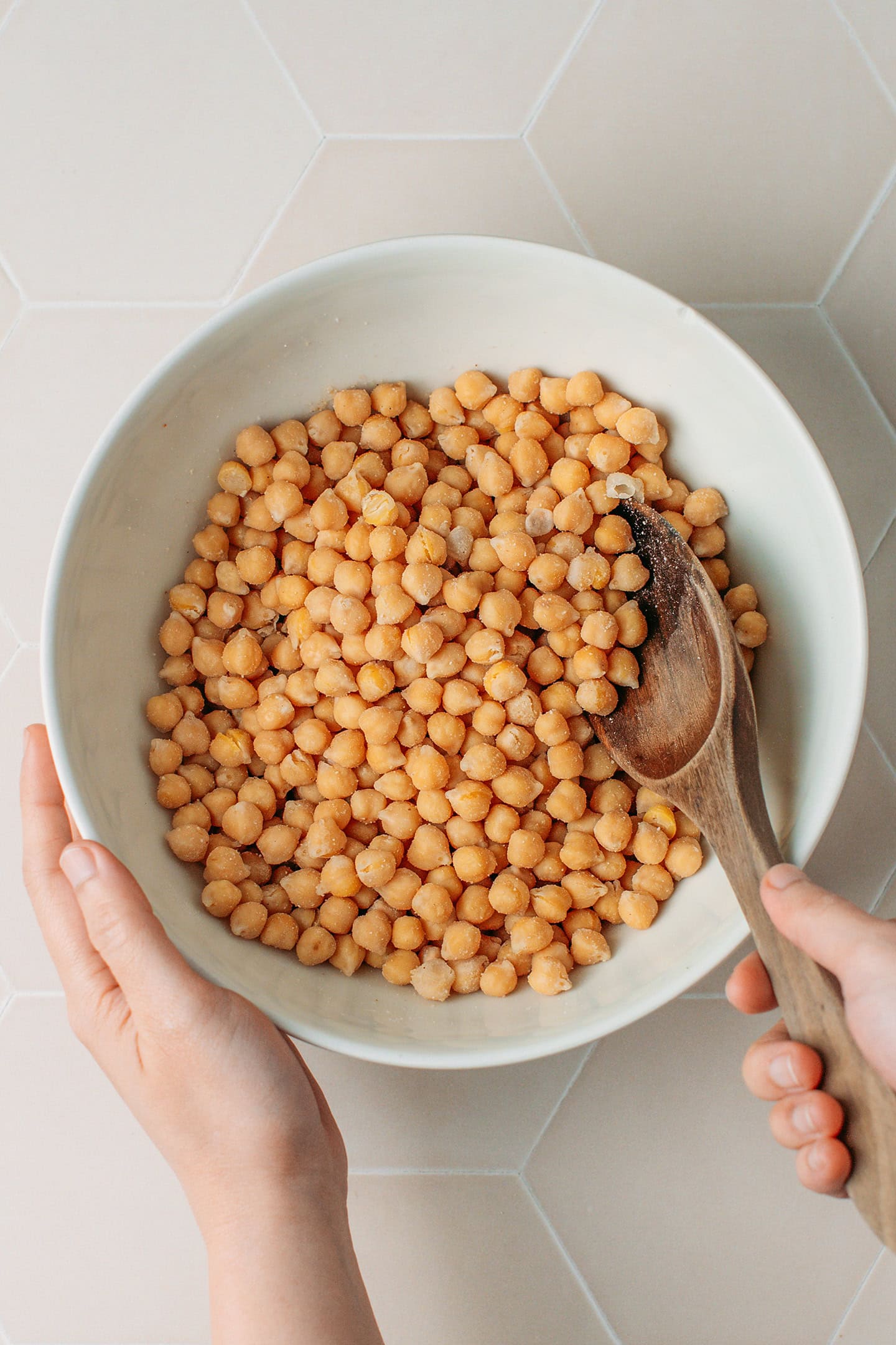 Tossing cooked chickpeas with tempeh starter.