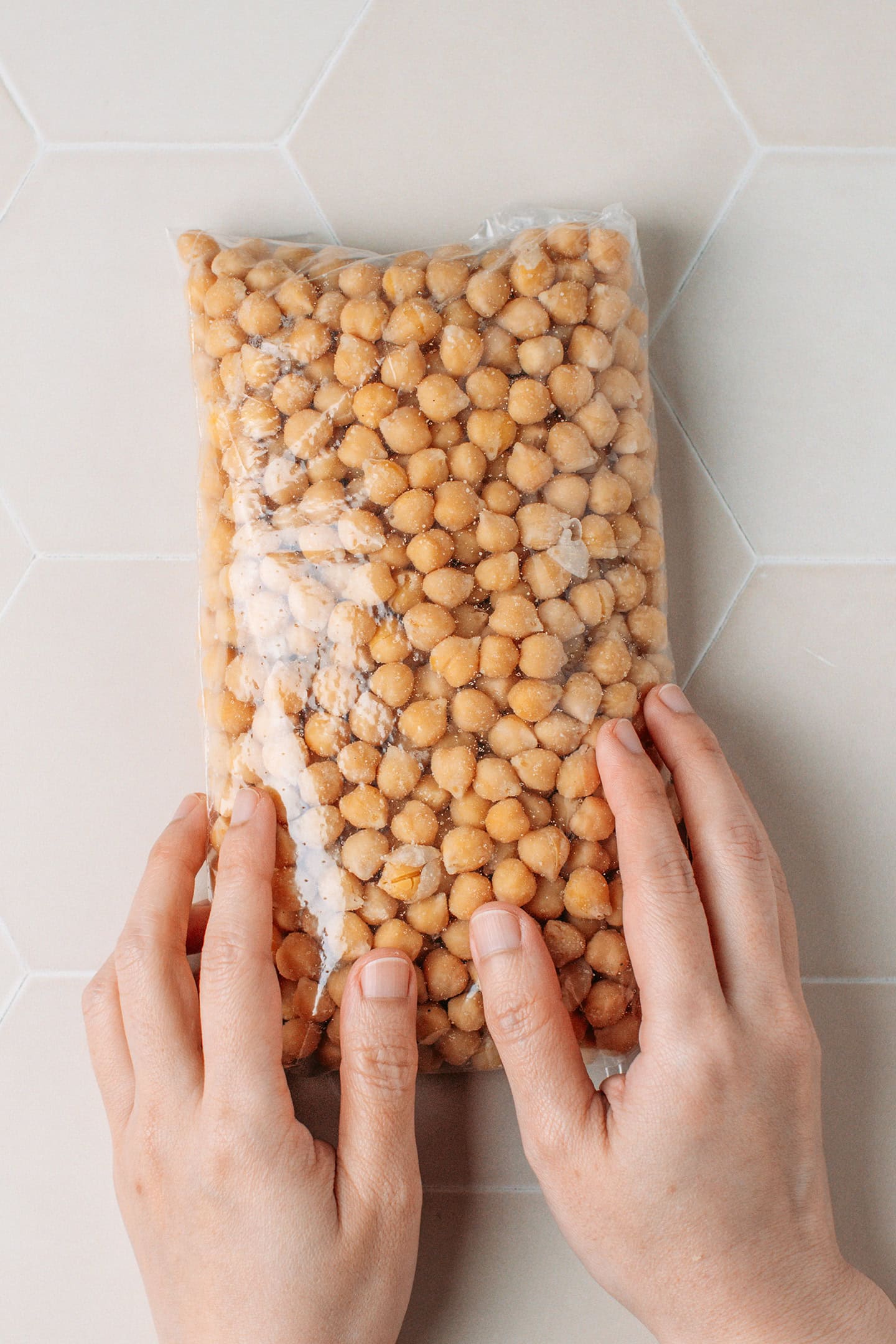 Shaping a bag containing cooked chickpeas into a loaf.
