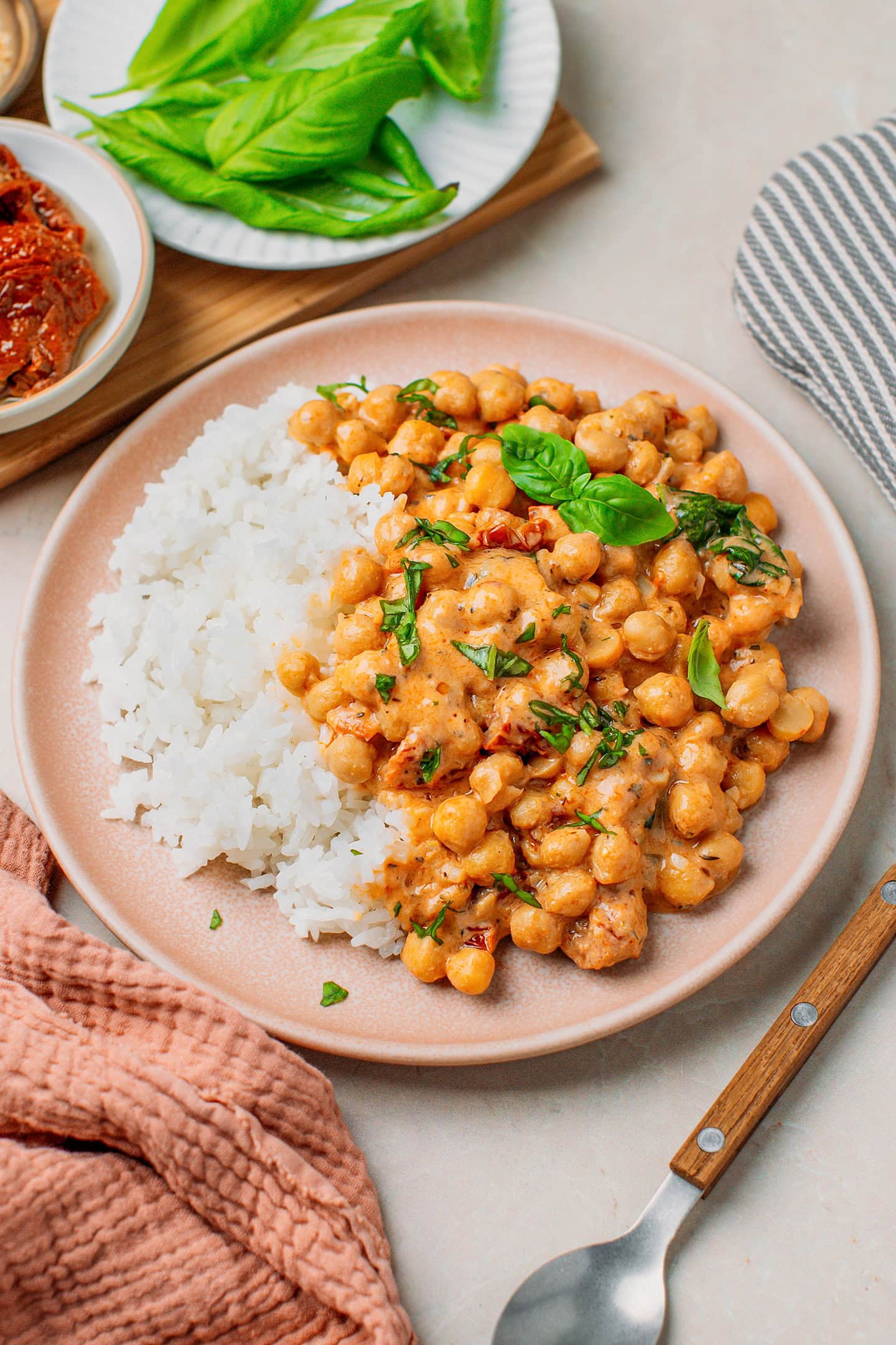 Pink plate filled with rice and creamy Marry Me chickpeas.