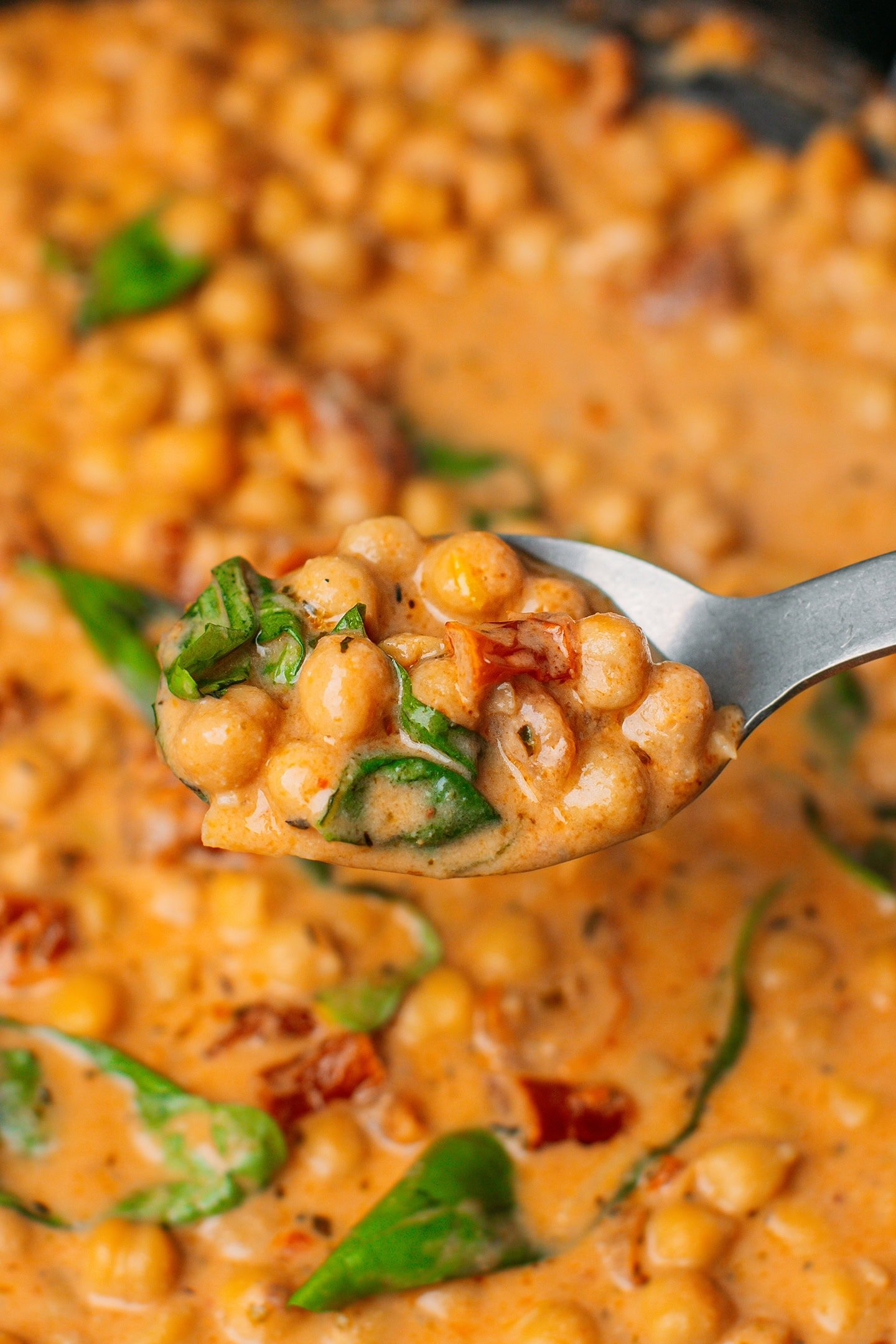 Close-up of a spoonful of Marry Me chickpeas.