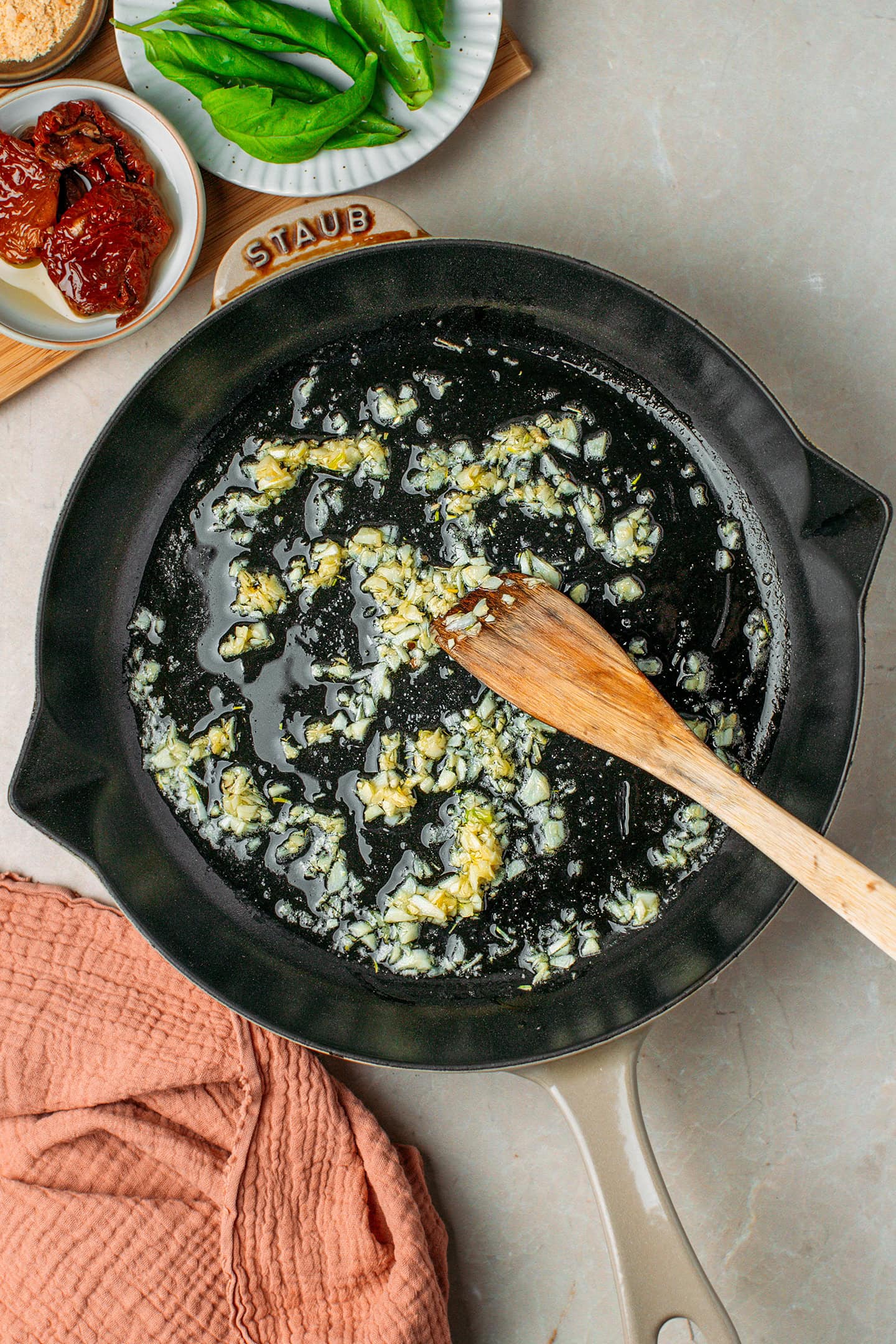 Saut&eacute;ed minced garlic in a skillet.