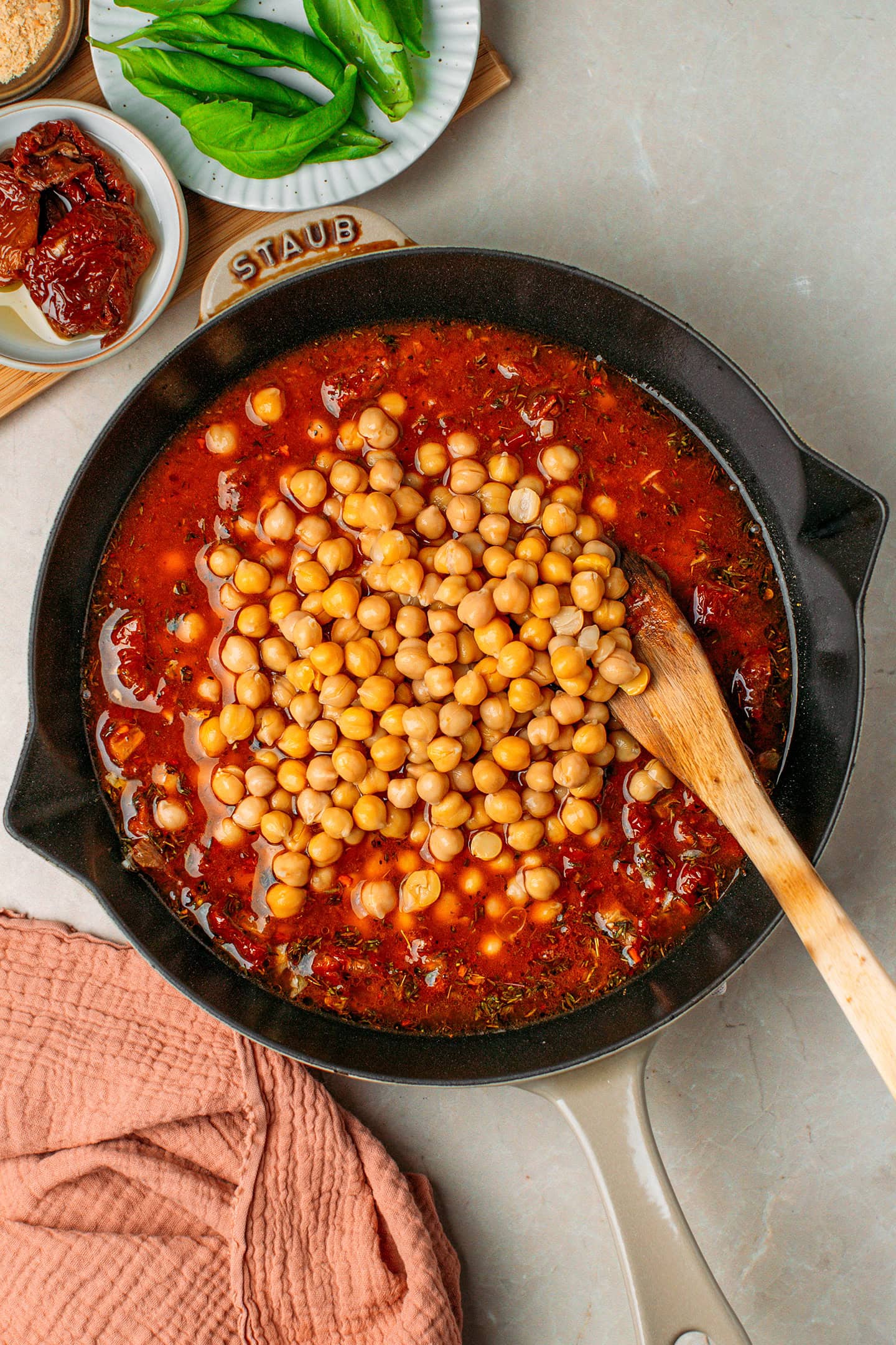 Tuscan sauce and cooked chickpeas in a skillet.