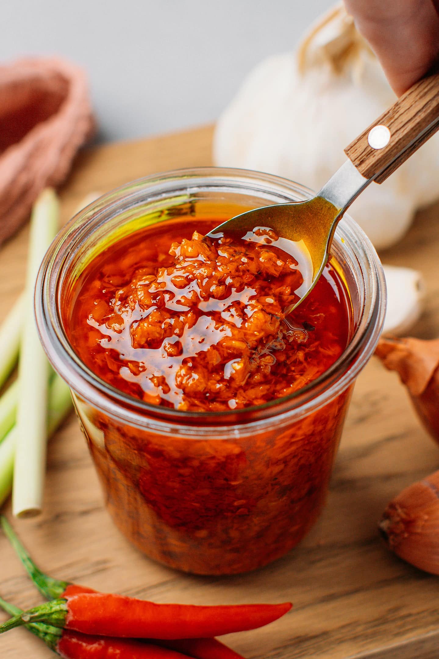 Stirring a spoon into a jar of Vietnamese sate.