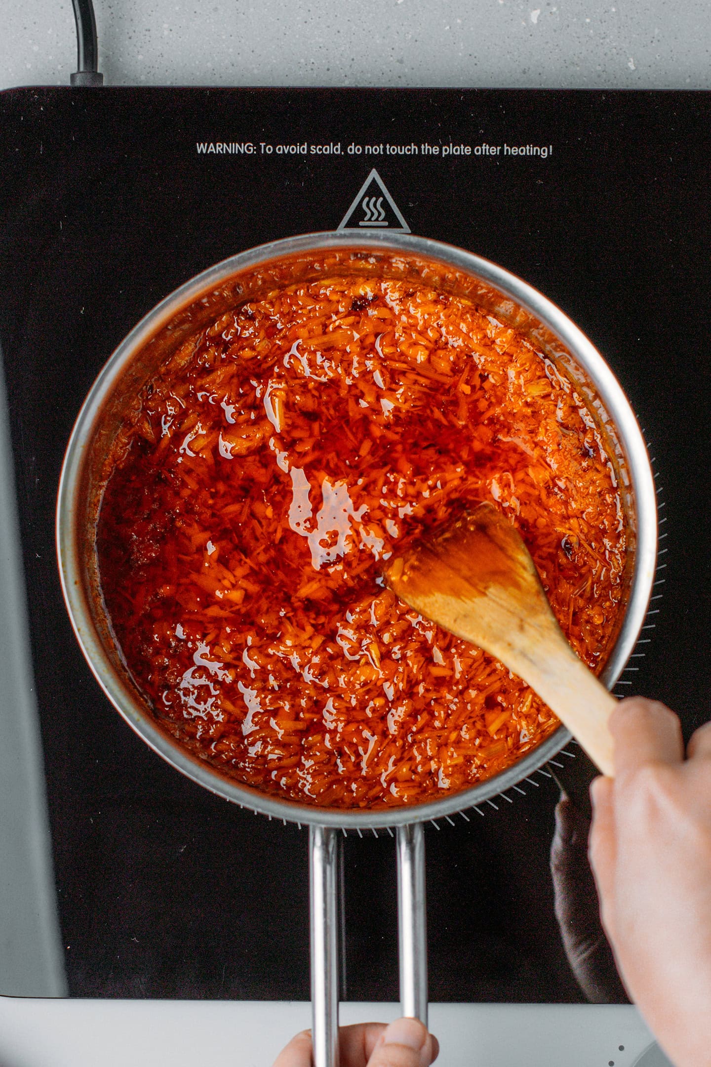 Stirring Vietnamese sate in a saucepan.