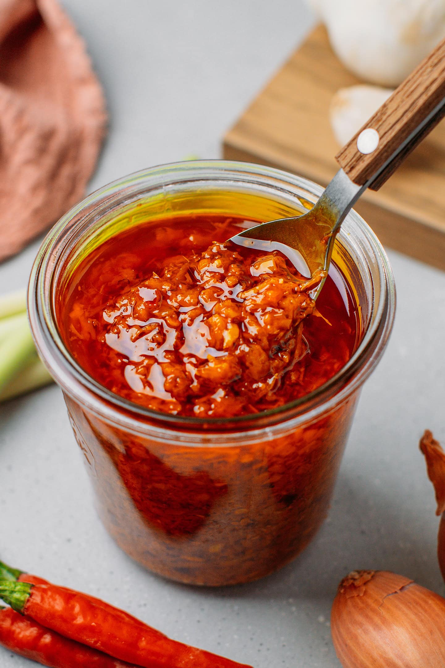 Jar of chili oil with chopped lemongrass, shallots, and chilies.