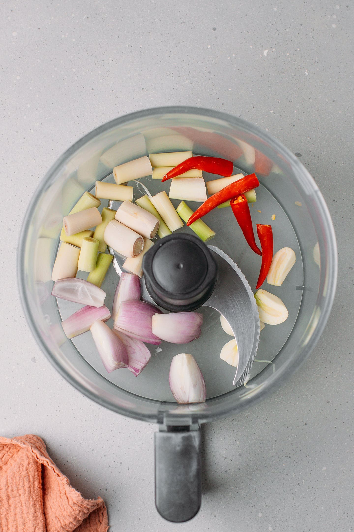 Chopped lemongrass, shallots, garlic, and chilies in a food processor.