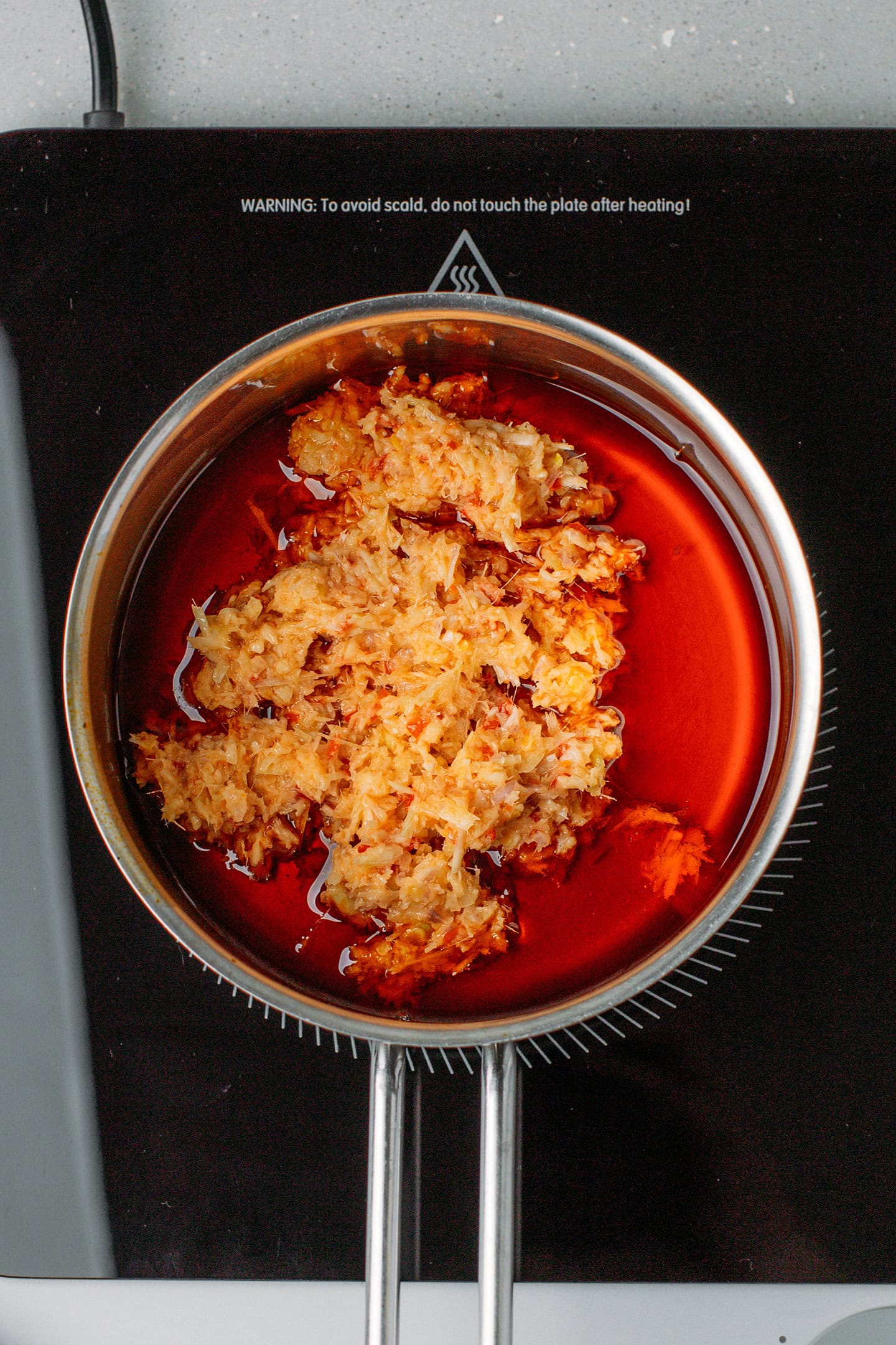 Finely chopped lemongrass, shallots, garlic, and chili in a saucepan.
