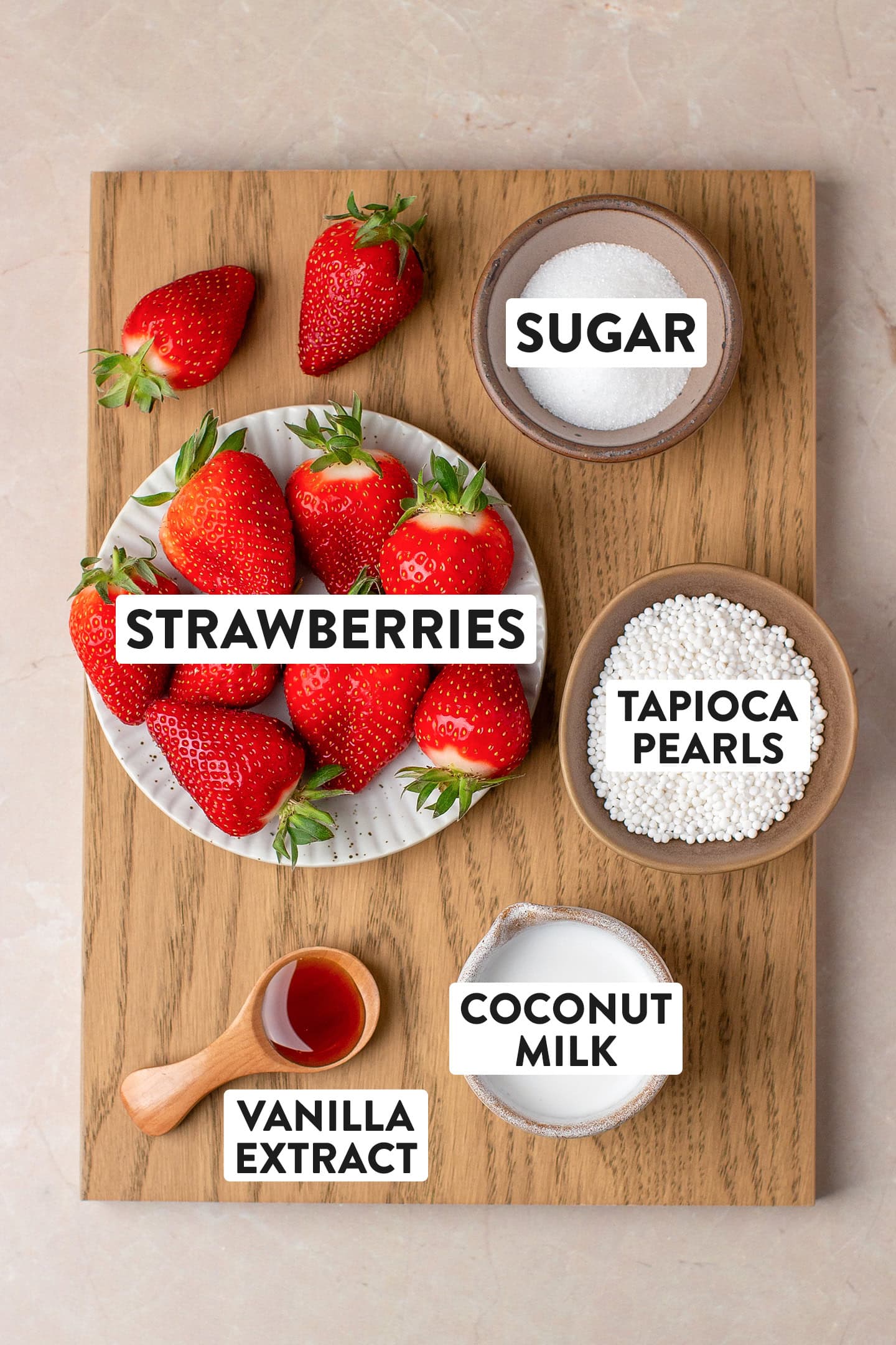 Ingredients like strawberries, tapioca pearls, sugar, and coconut milk.