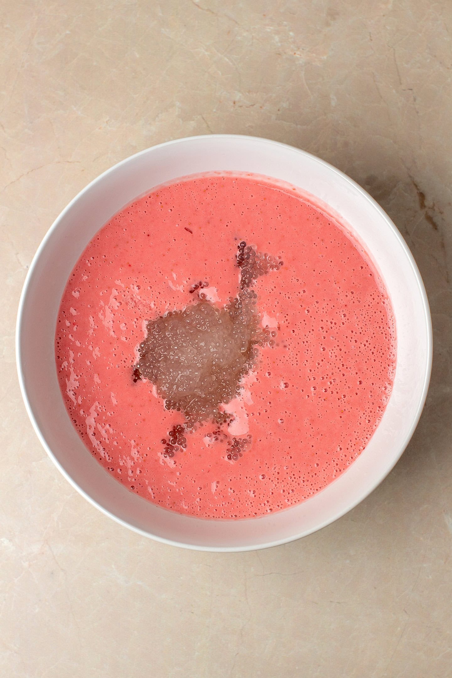 Blended strawberries, and tapioca pearls in a mixing bowl.