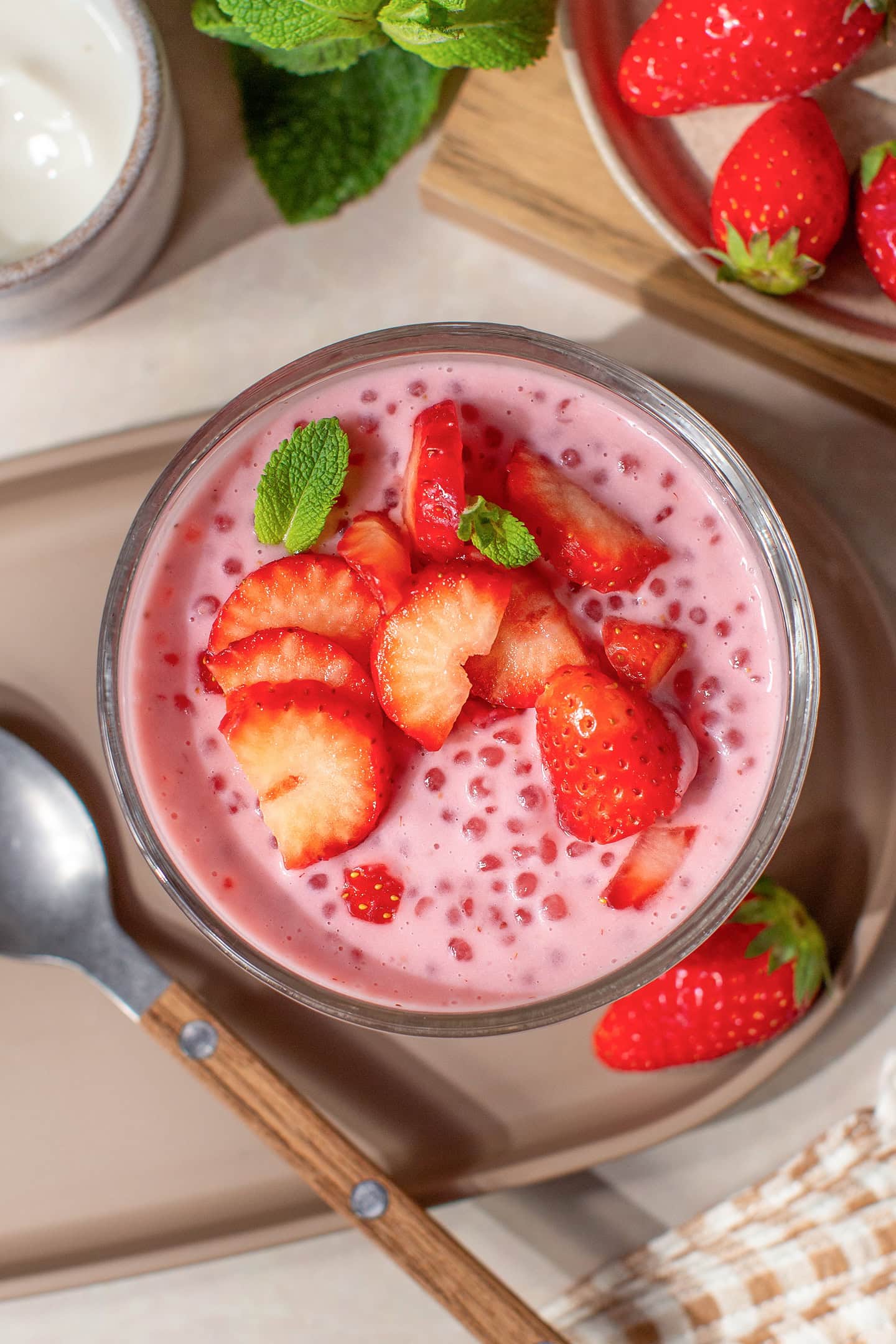 Top view of a strawberry sago topped with sliced strawberries.