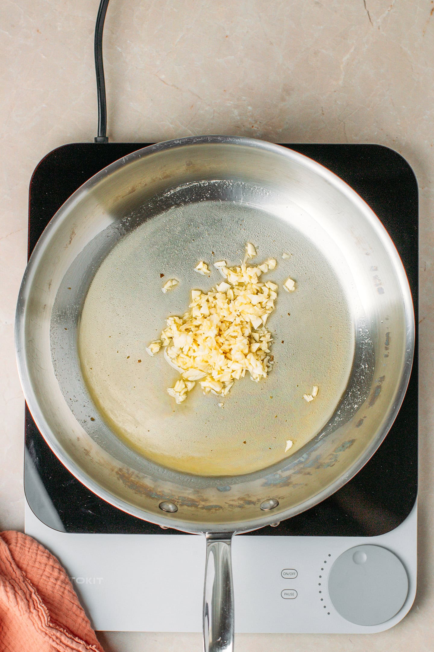 Chopped garlic and melted butter in a skillet.