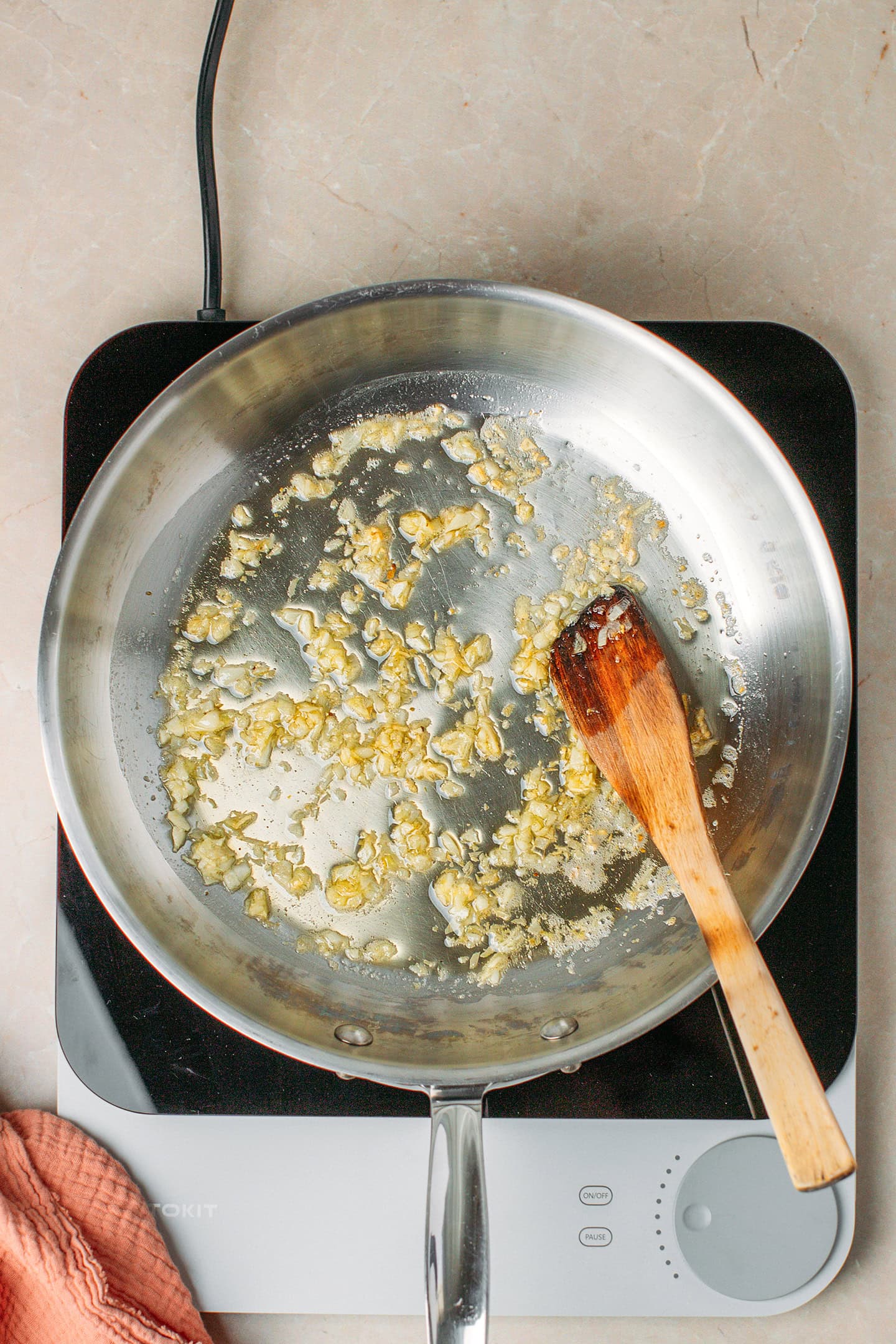 Saut&eacute;ed garlic in a skillet.
