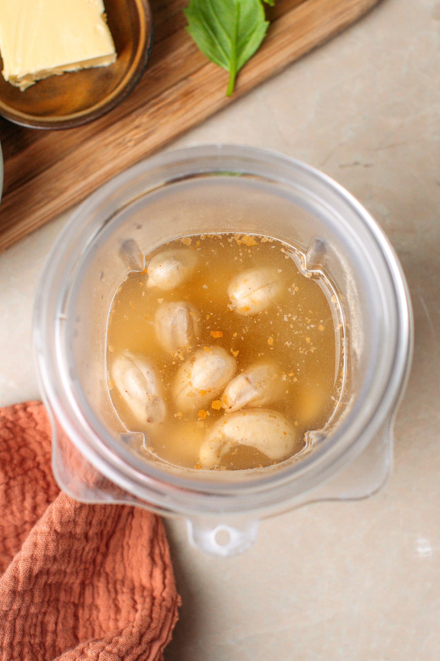 Raw cashews, water, and nutritional yeast in a blender.
