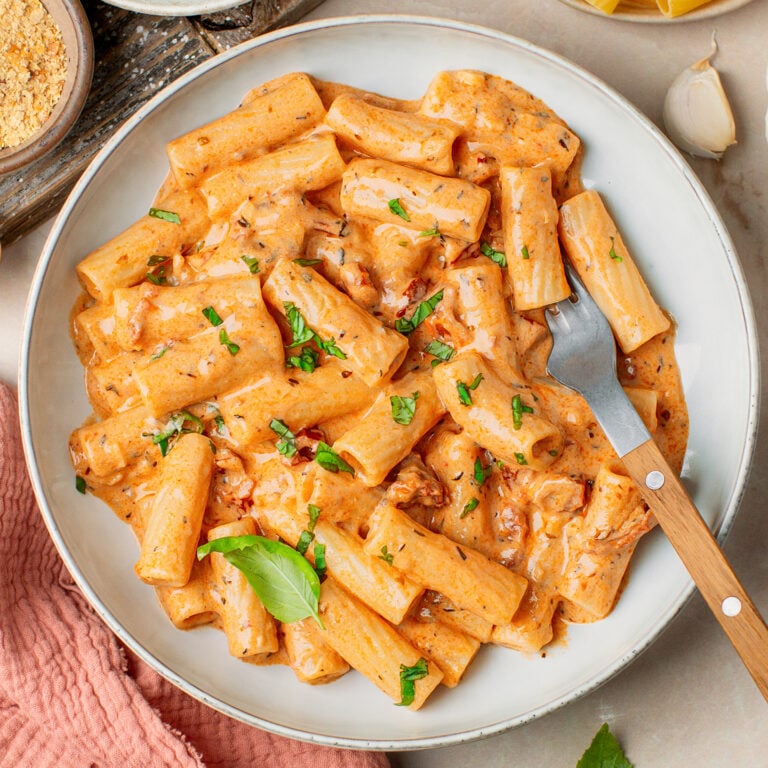 Pasta in marry me sauce topped with chopped basil in a plate.
