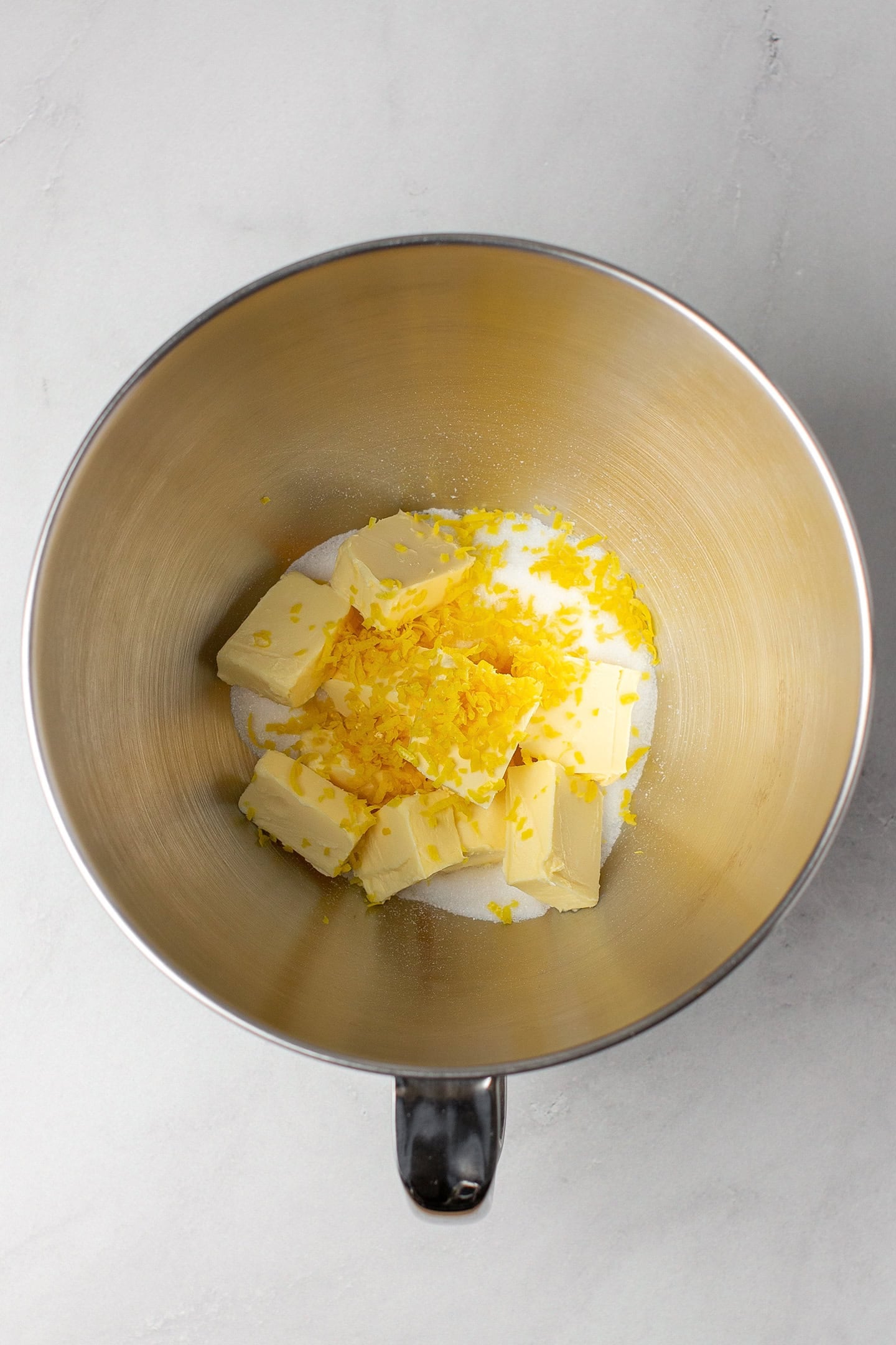 Sugar, diced butter, and lemon zest in a stand mixer.