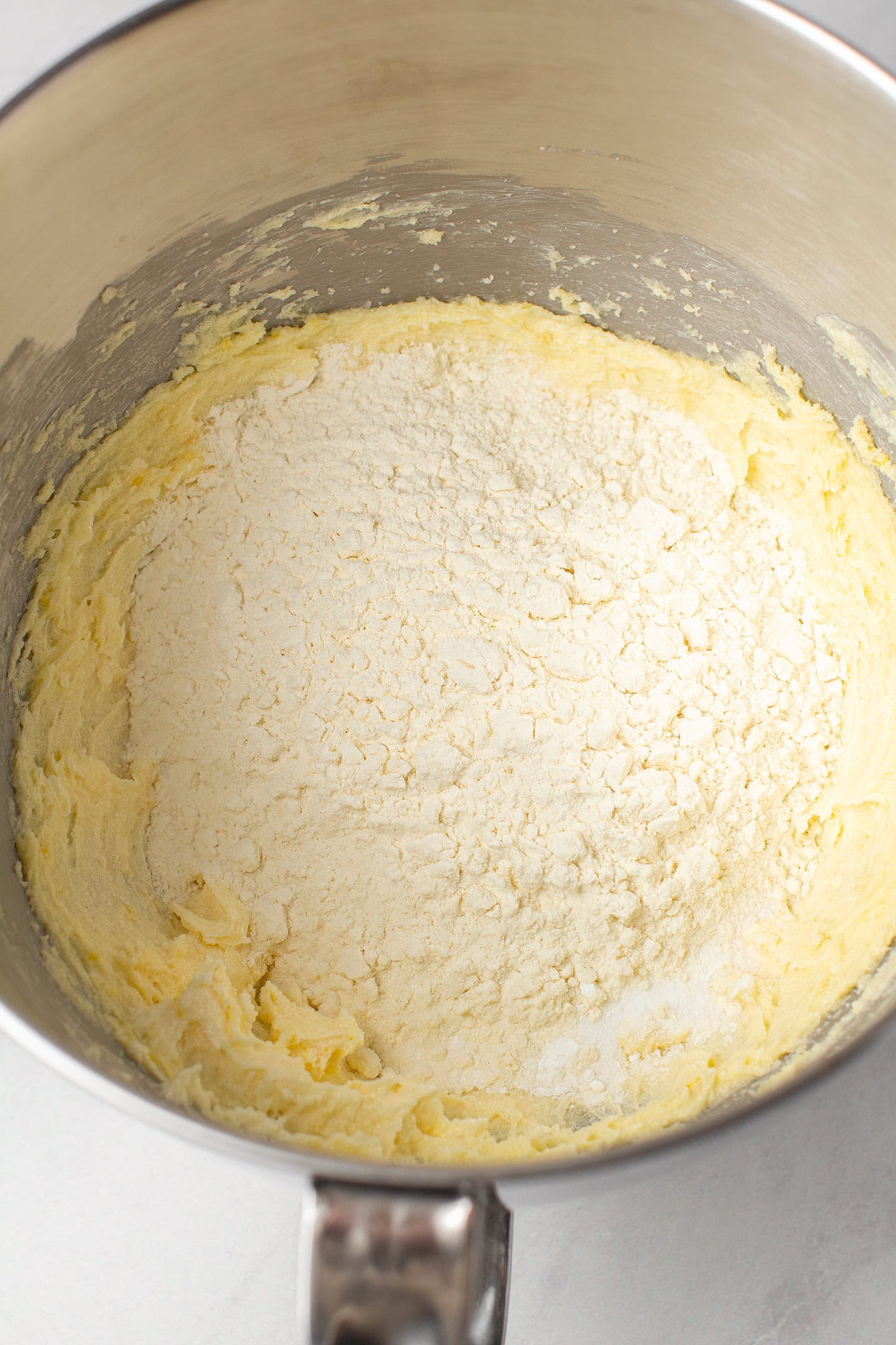 Creamed butter and flour in the bowl of a stand mixer.