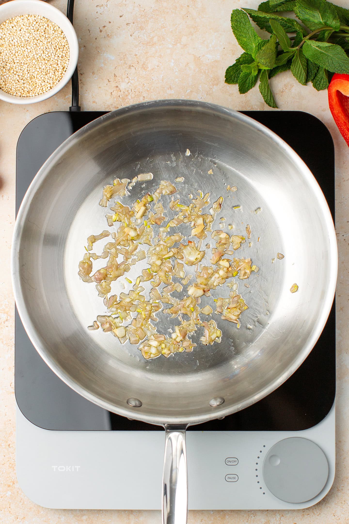 Saut&eacute;ed minced shallot in a skillet.