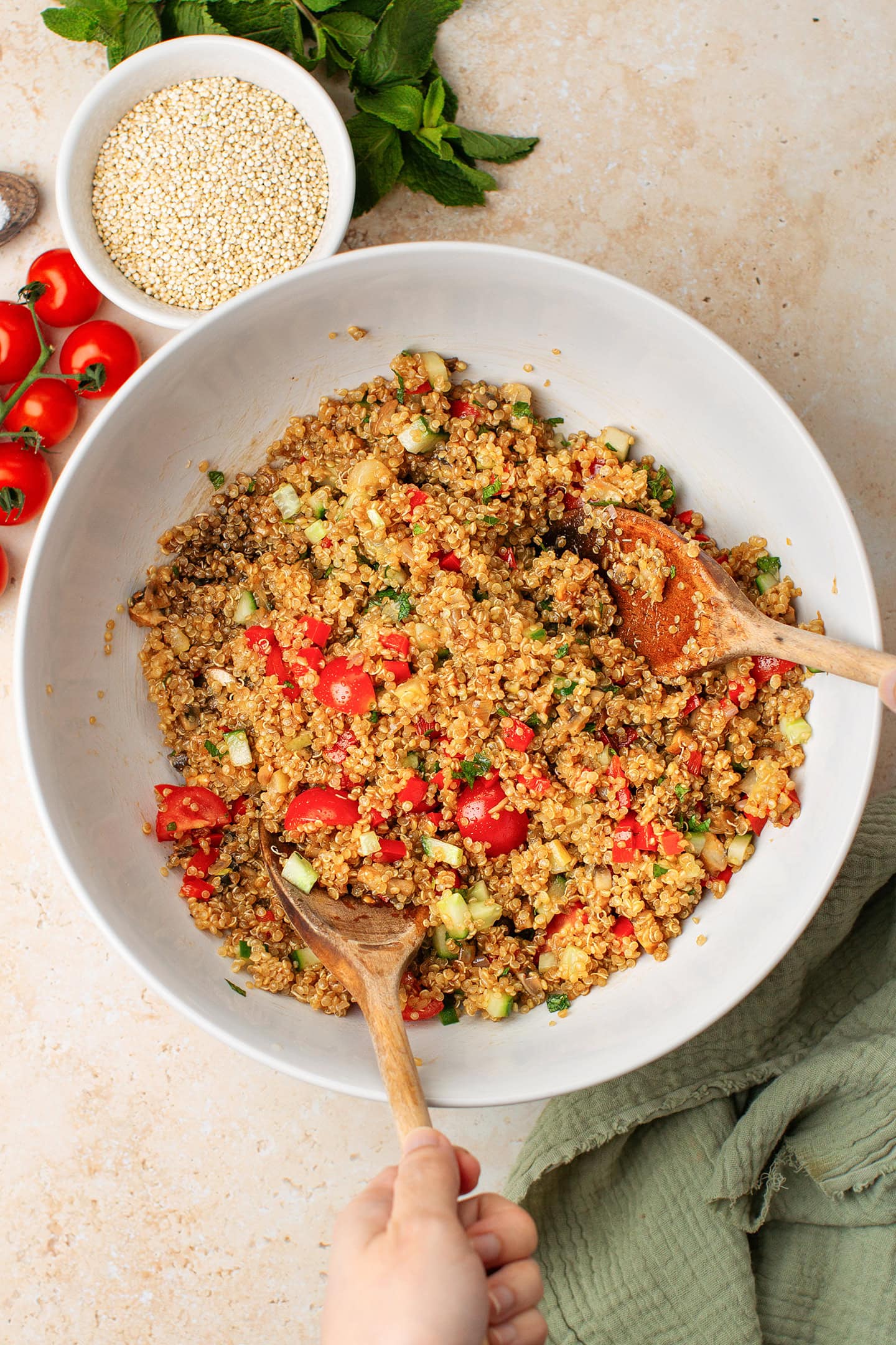 Quinoa tossed with vegetables and balsamic dressing in a bowl.