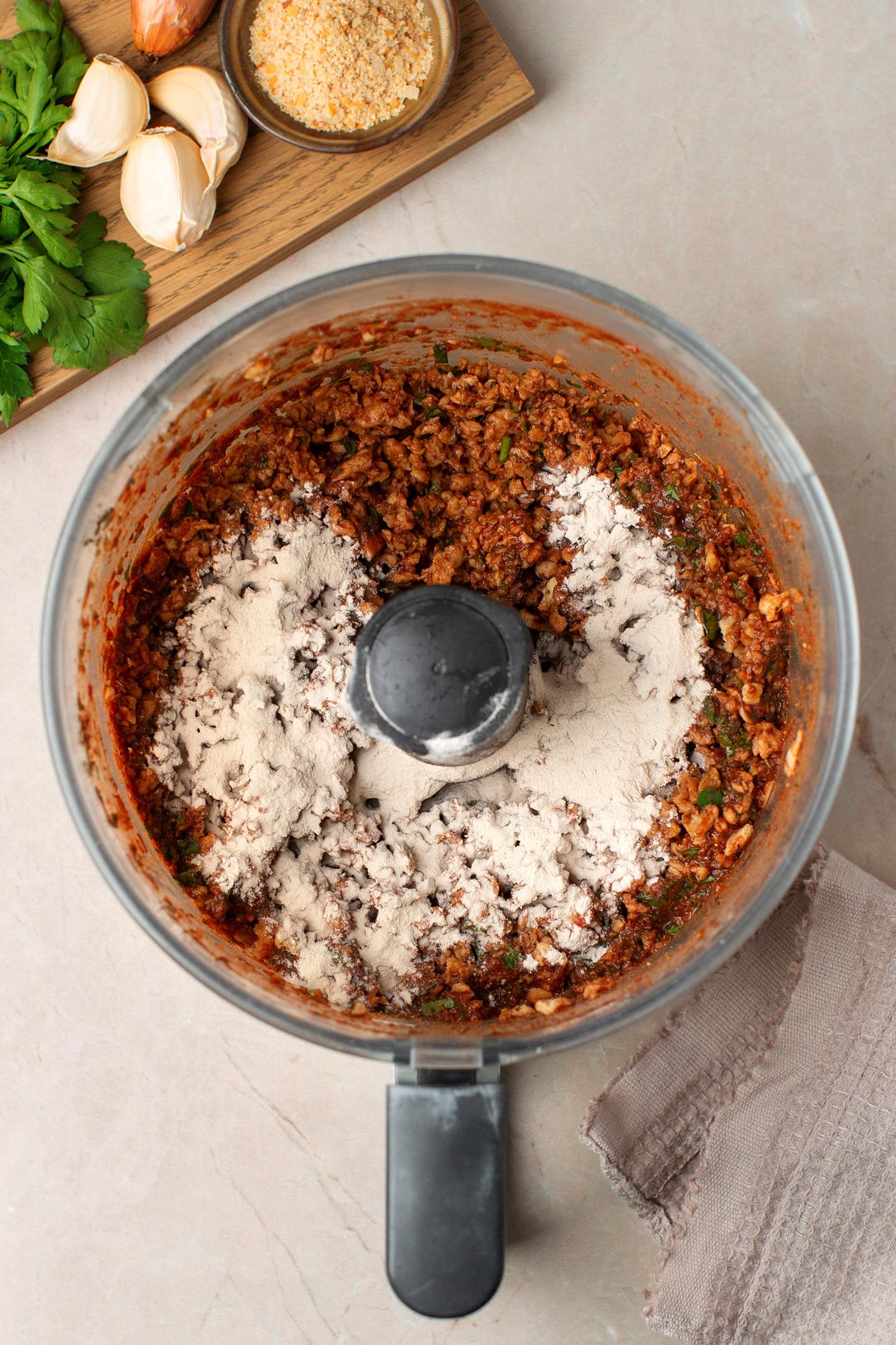 Vegan ground meat and psyllium husk powder in a food processor.