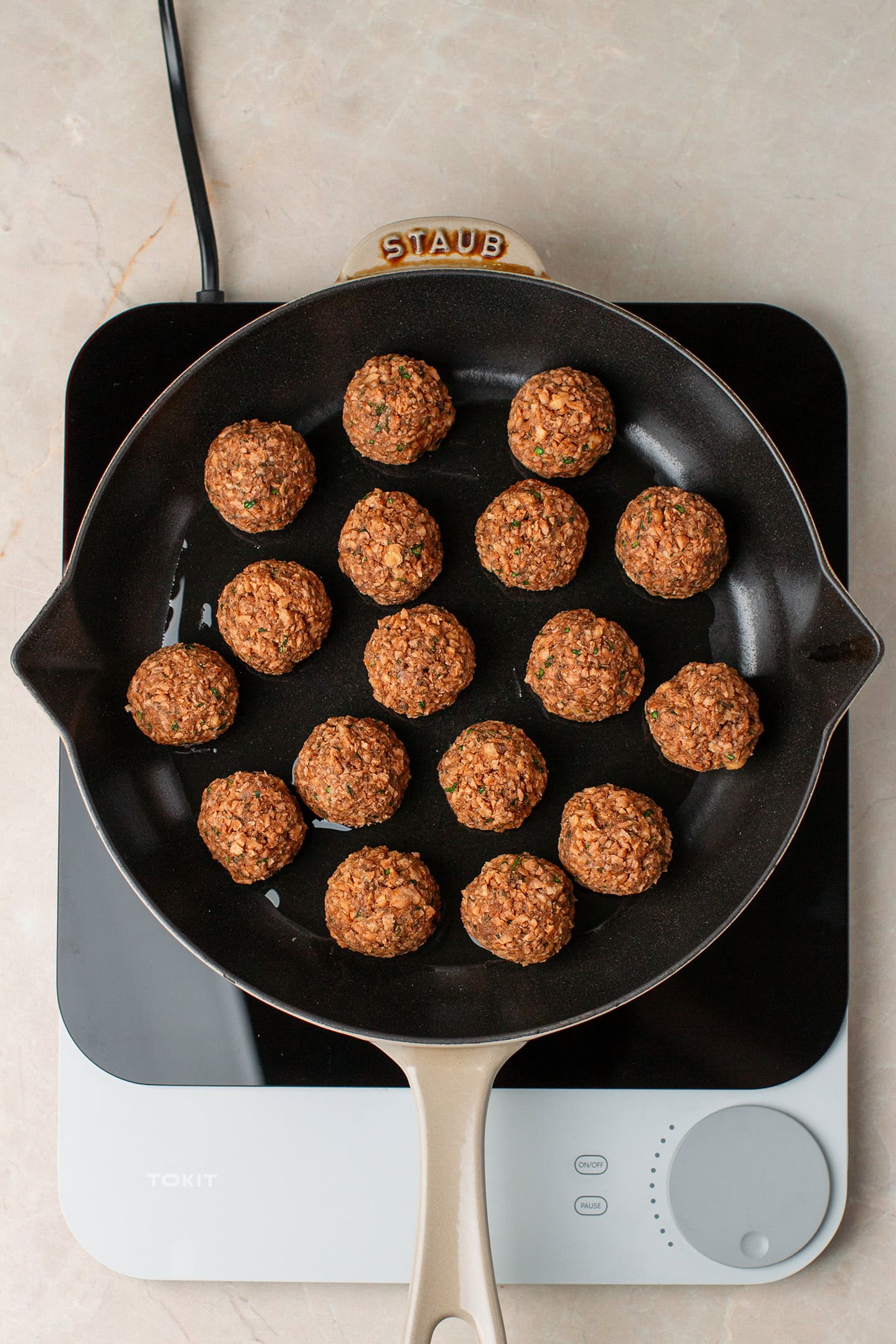 Vegan meatballs in a skillet.