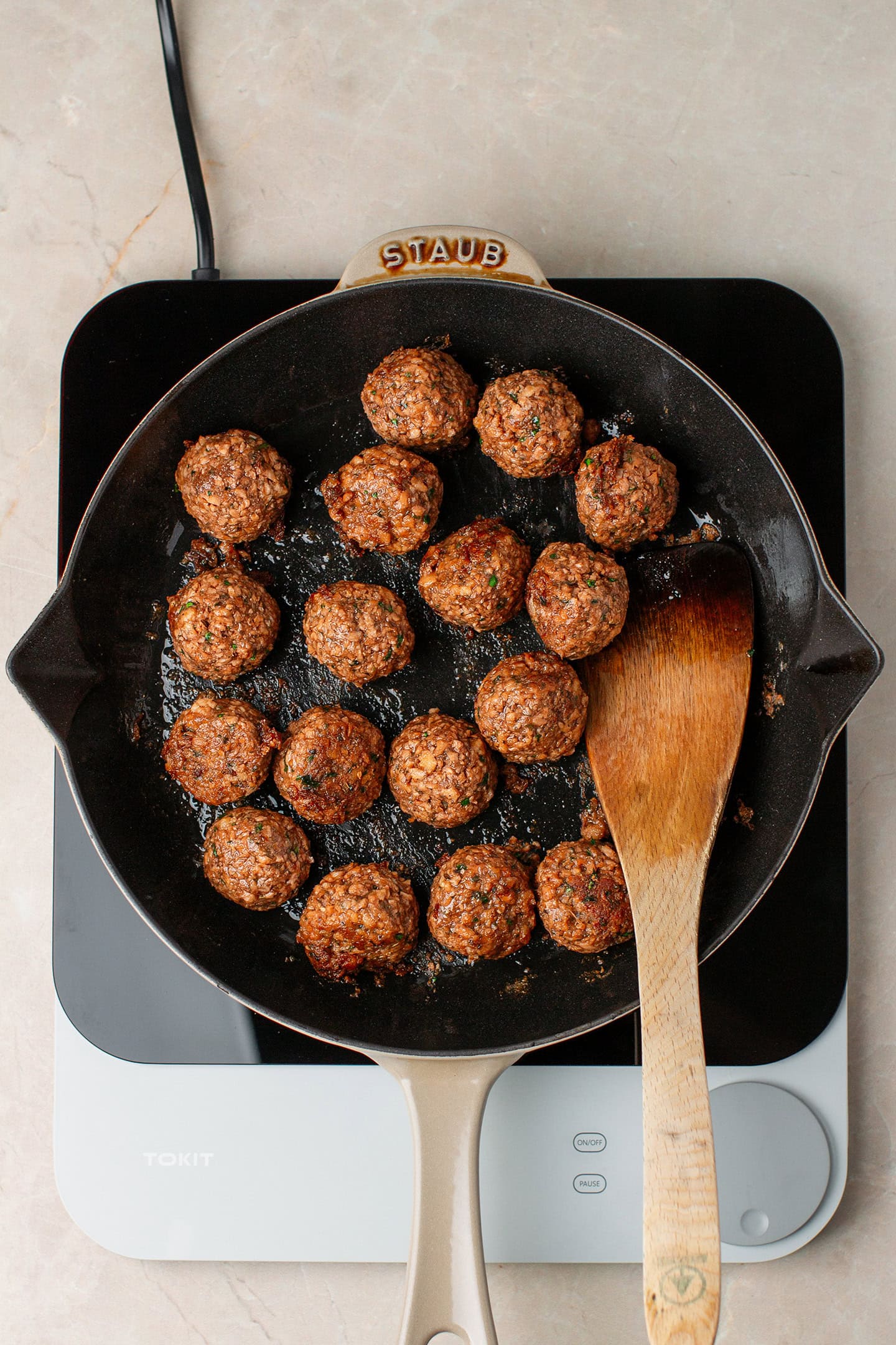 Saut&eacute;ed vegan meatballs in a skillet.