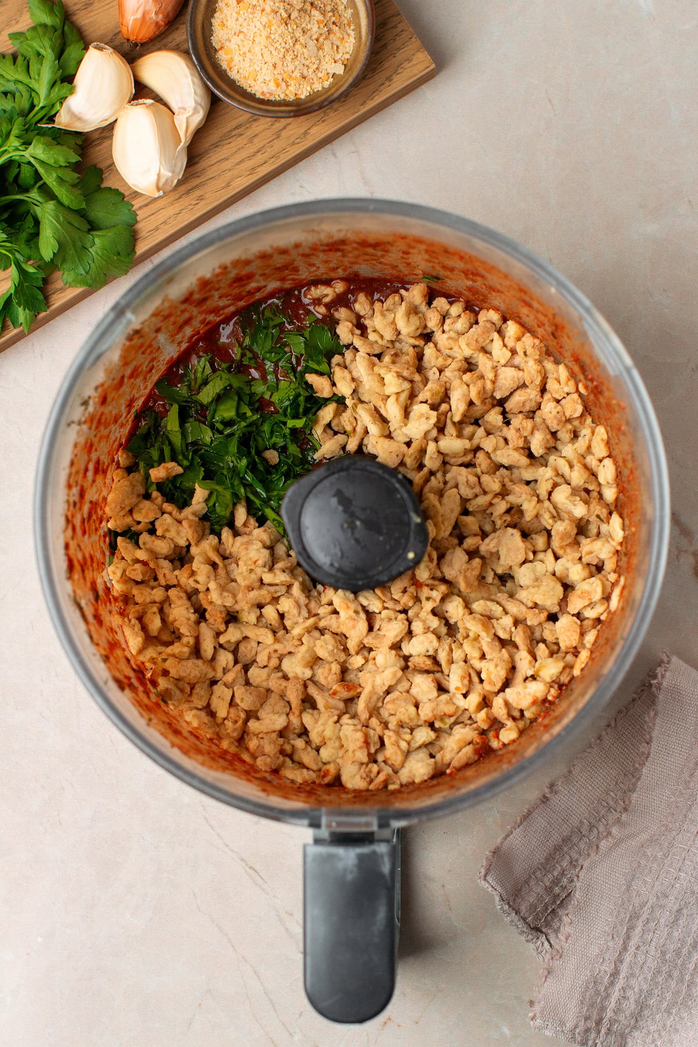 TVP chunks and parsley in a food processor.