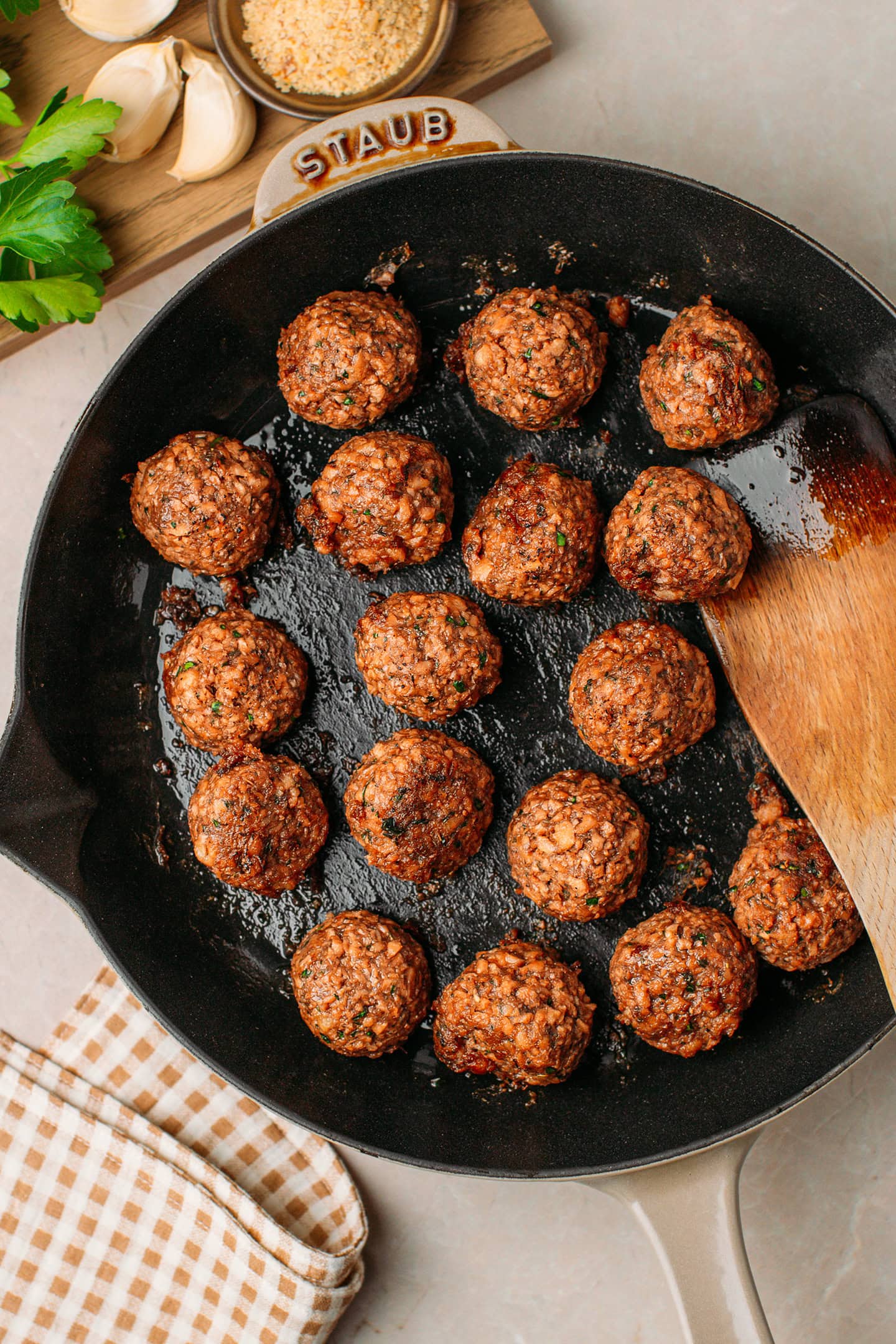 Saut&eacute;ed vegan meatballs in a skillet.