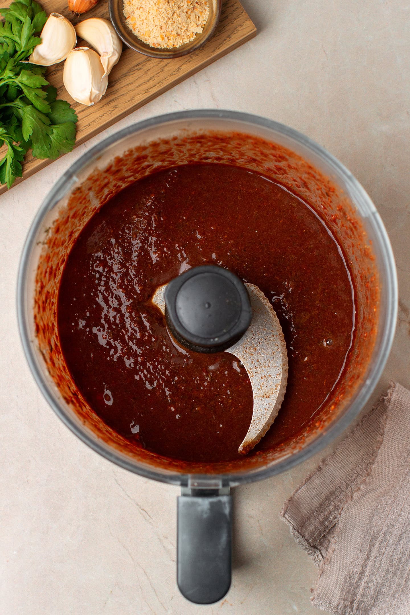 Processed seasonings like nutritional yeast, shallots, garlic, and Worcestershire sauce in a food processor.