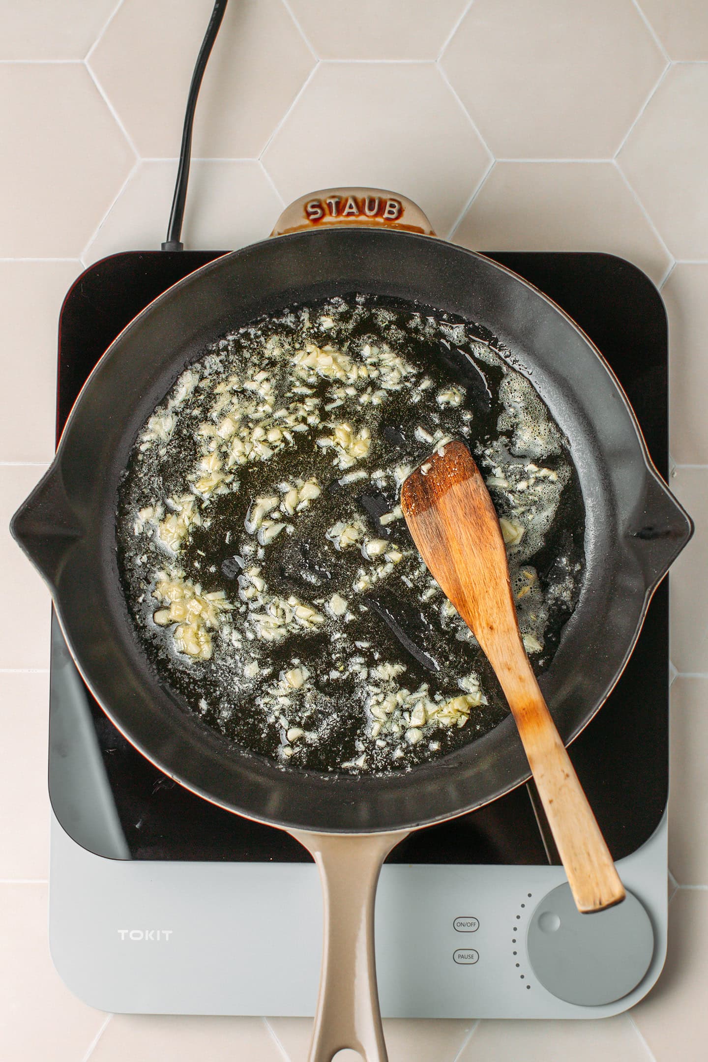 Saut&eacute;ed garlic in melted butter in a skillet.