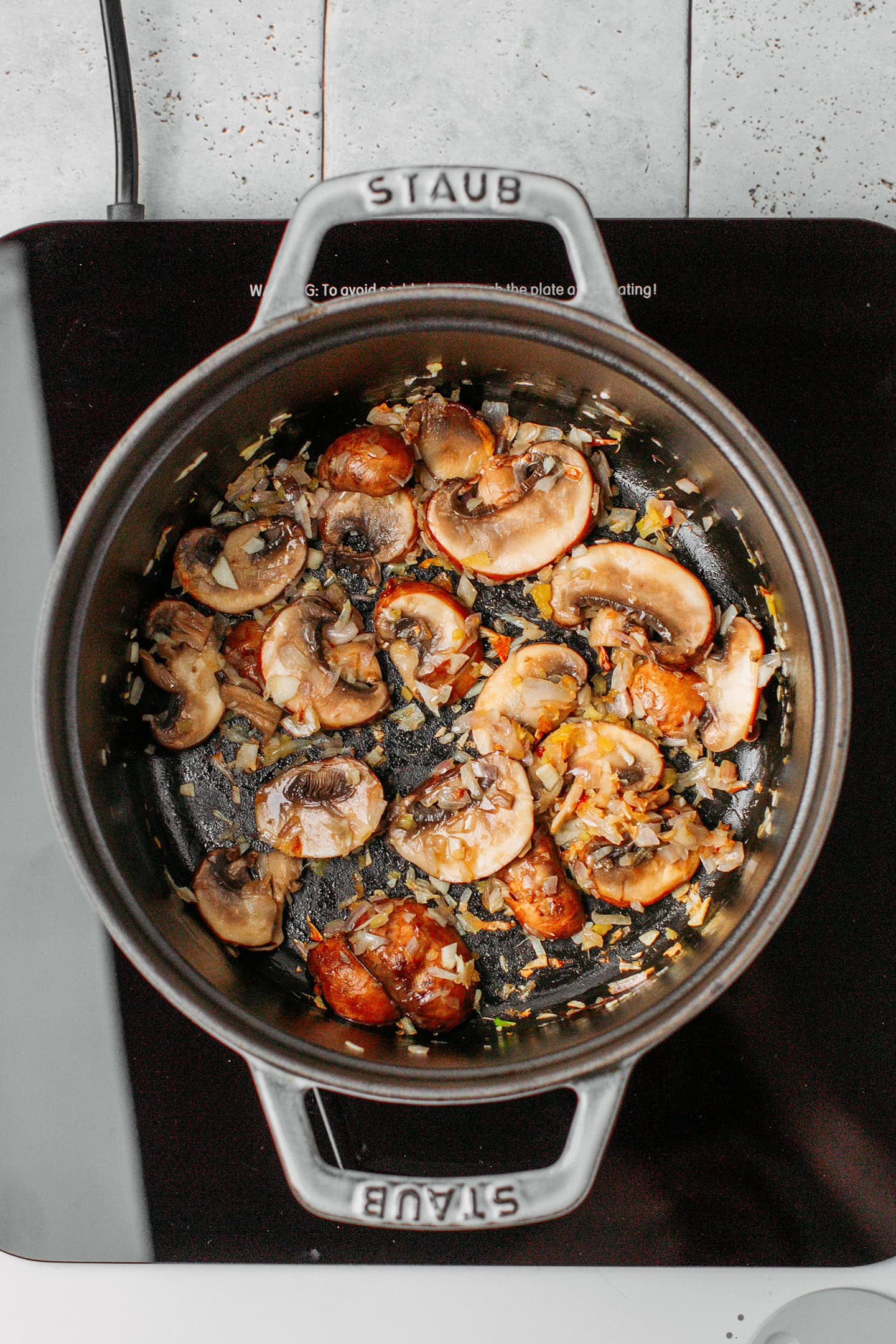 Saut&eacute;ed mushrooms in a pot.
