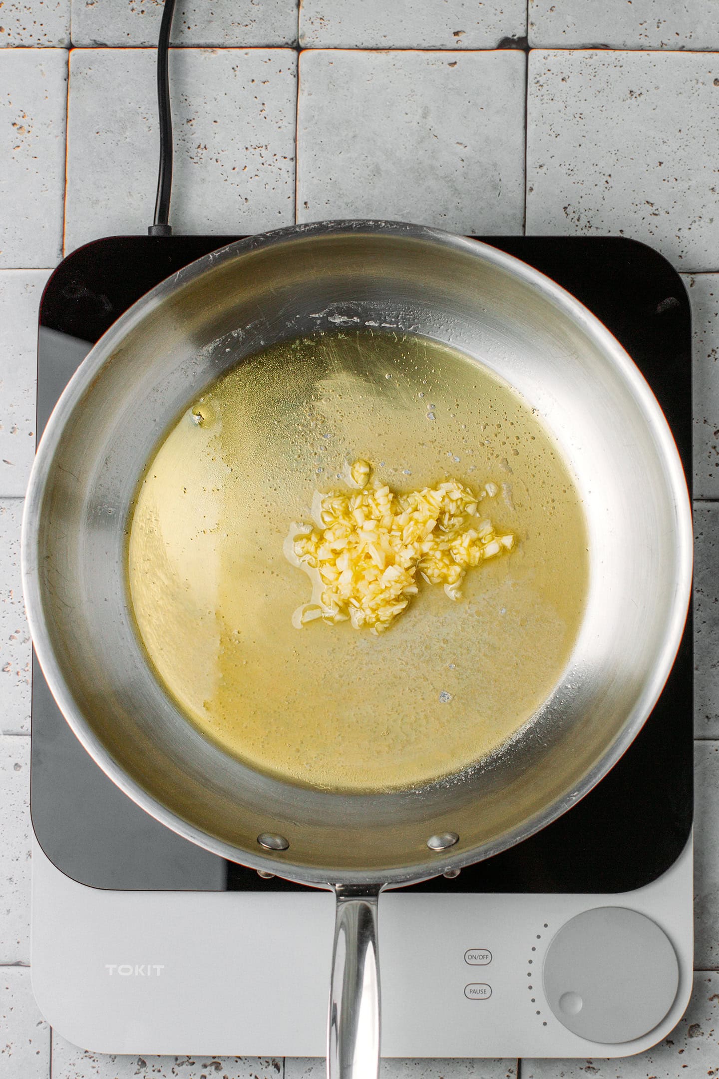 Minced garlic and melted butter in a skillet.